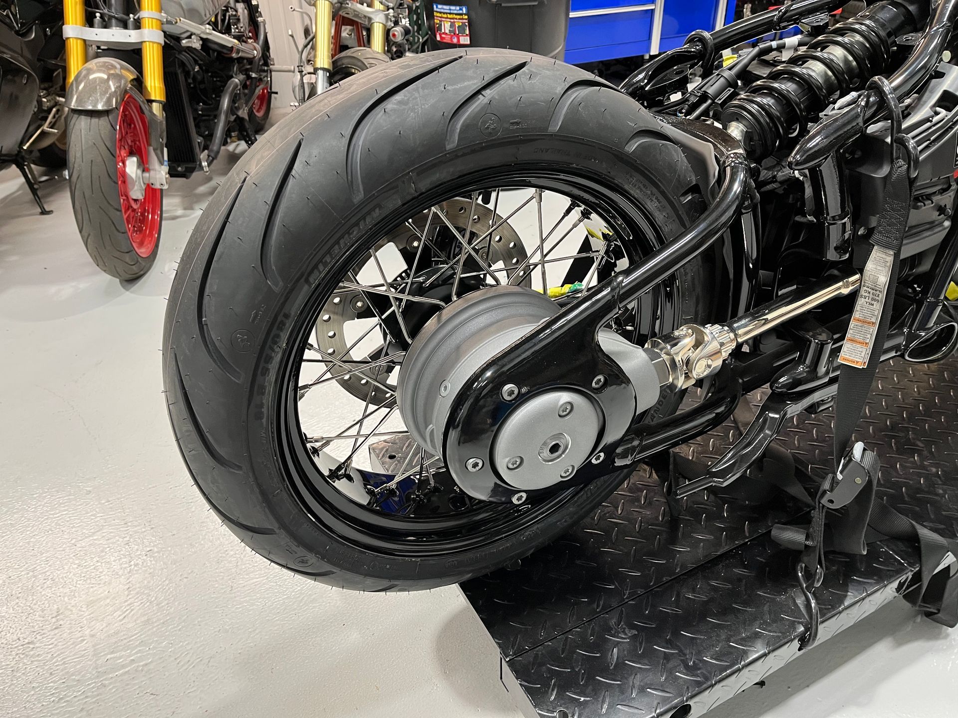 A motorcycle is sitting on a table in a garage.