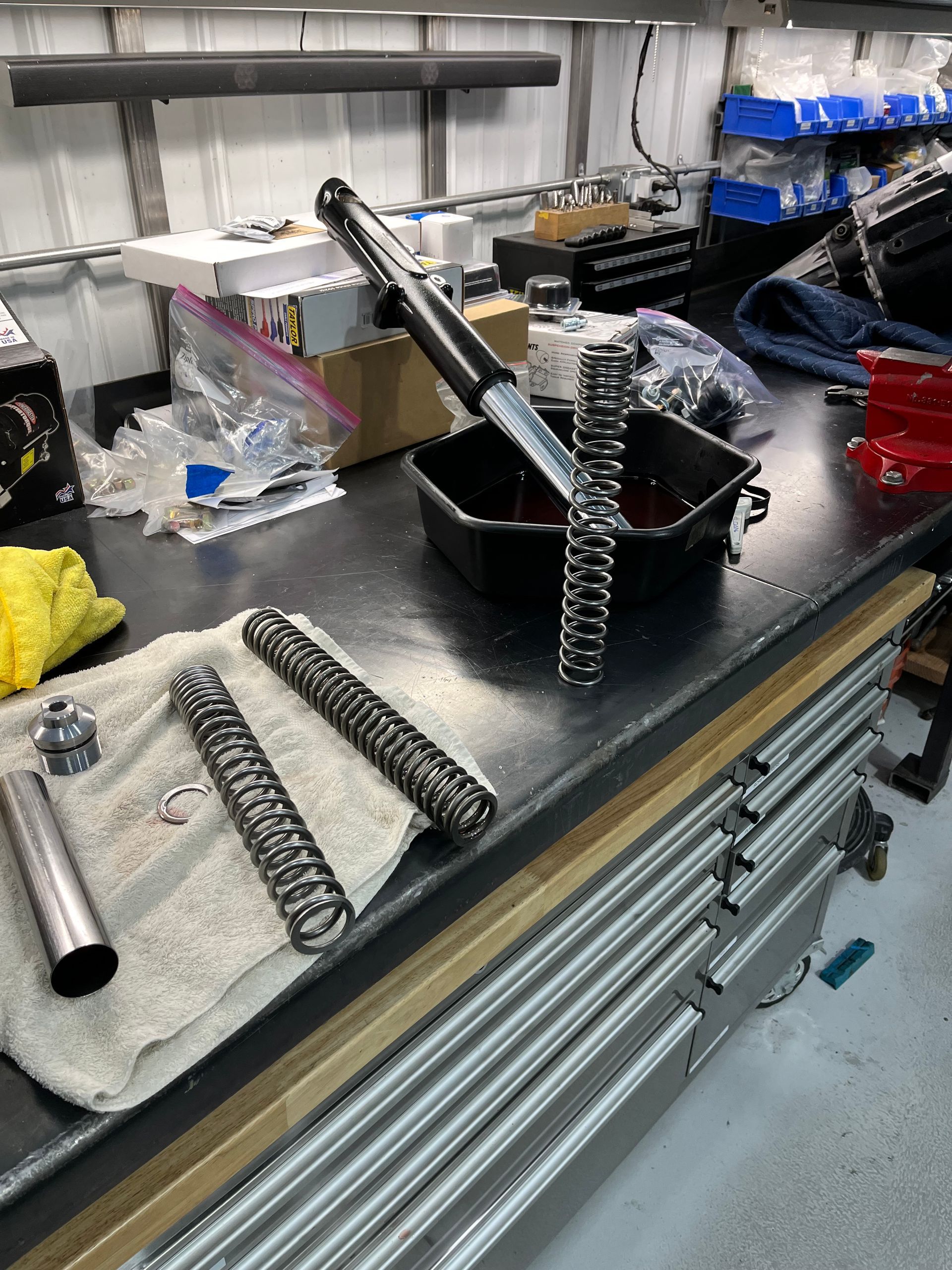 A bunch of springs are sitting on a table in a garage.
