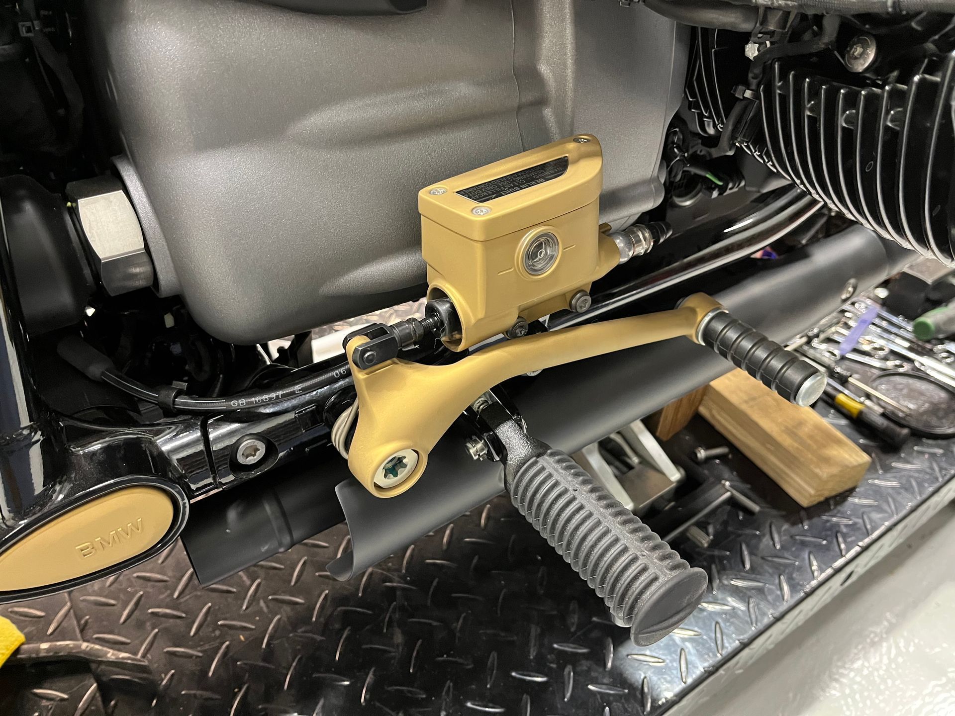 A close up of a motorcycle engine with a brake fluid reservoir