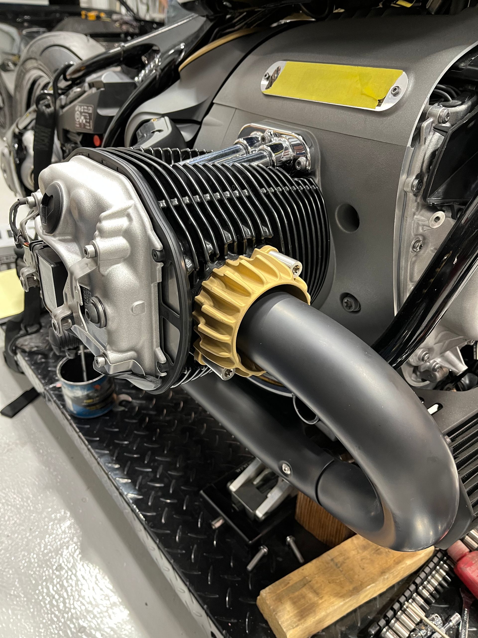 A close up of a motorcycle engine in a garage.