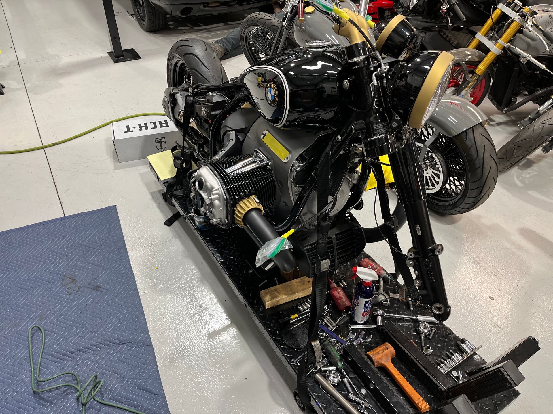 A motorcycle is being worked on in a garage.