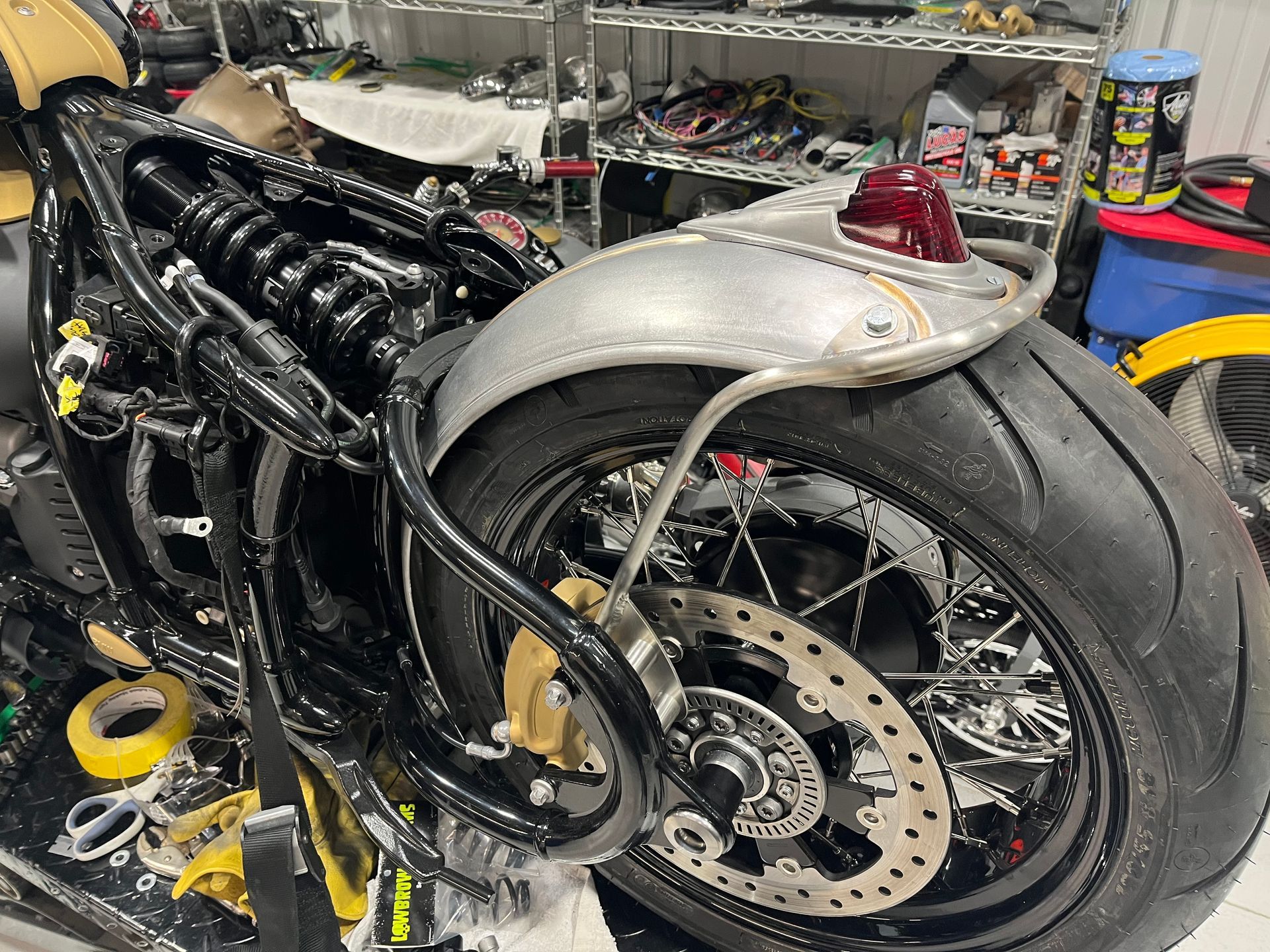 A motorcycle is being worked on in a garage.