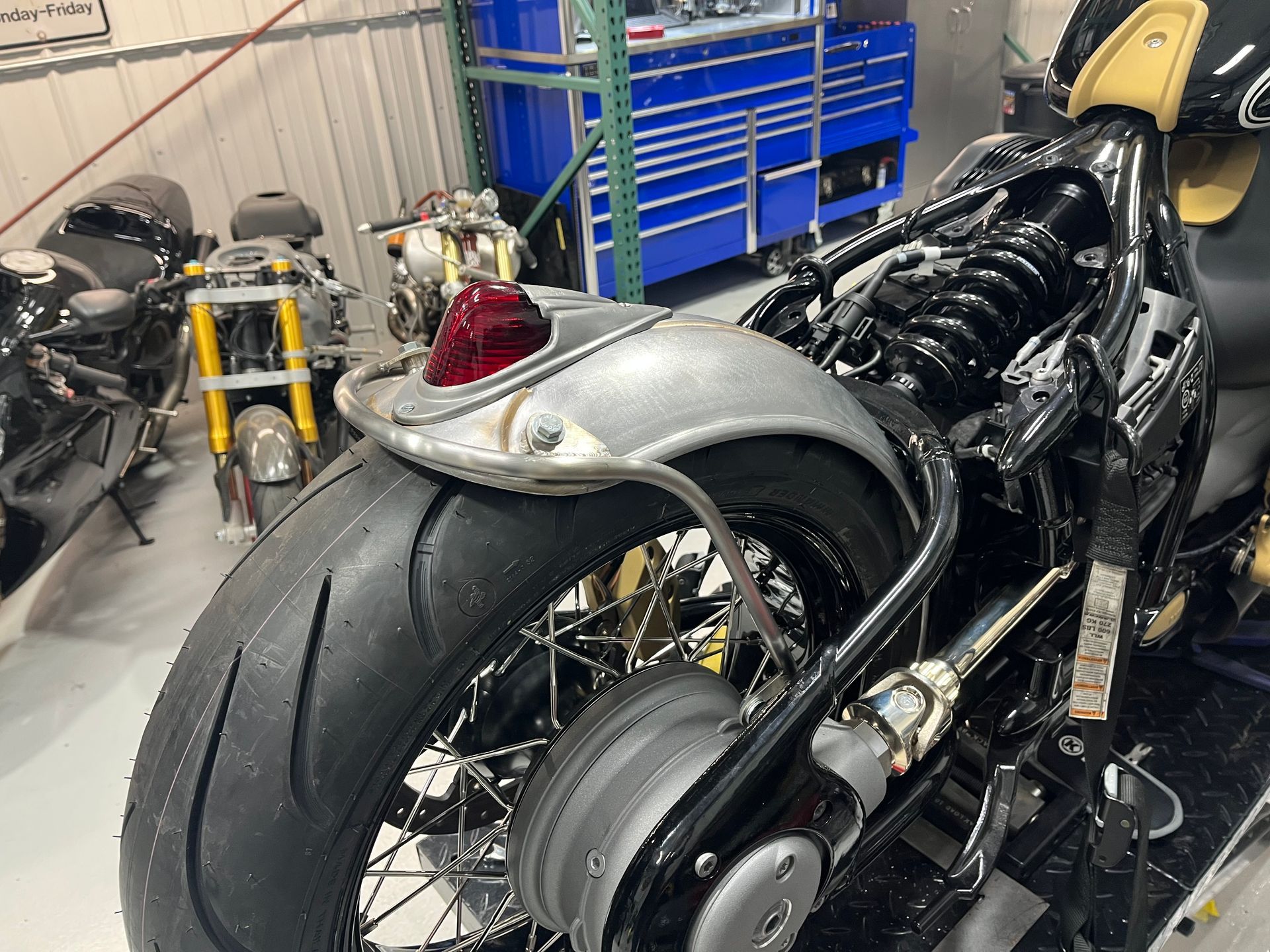 A motorcycle is being worked on in a garage.