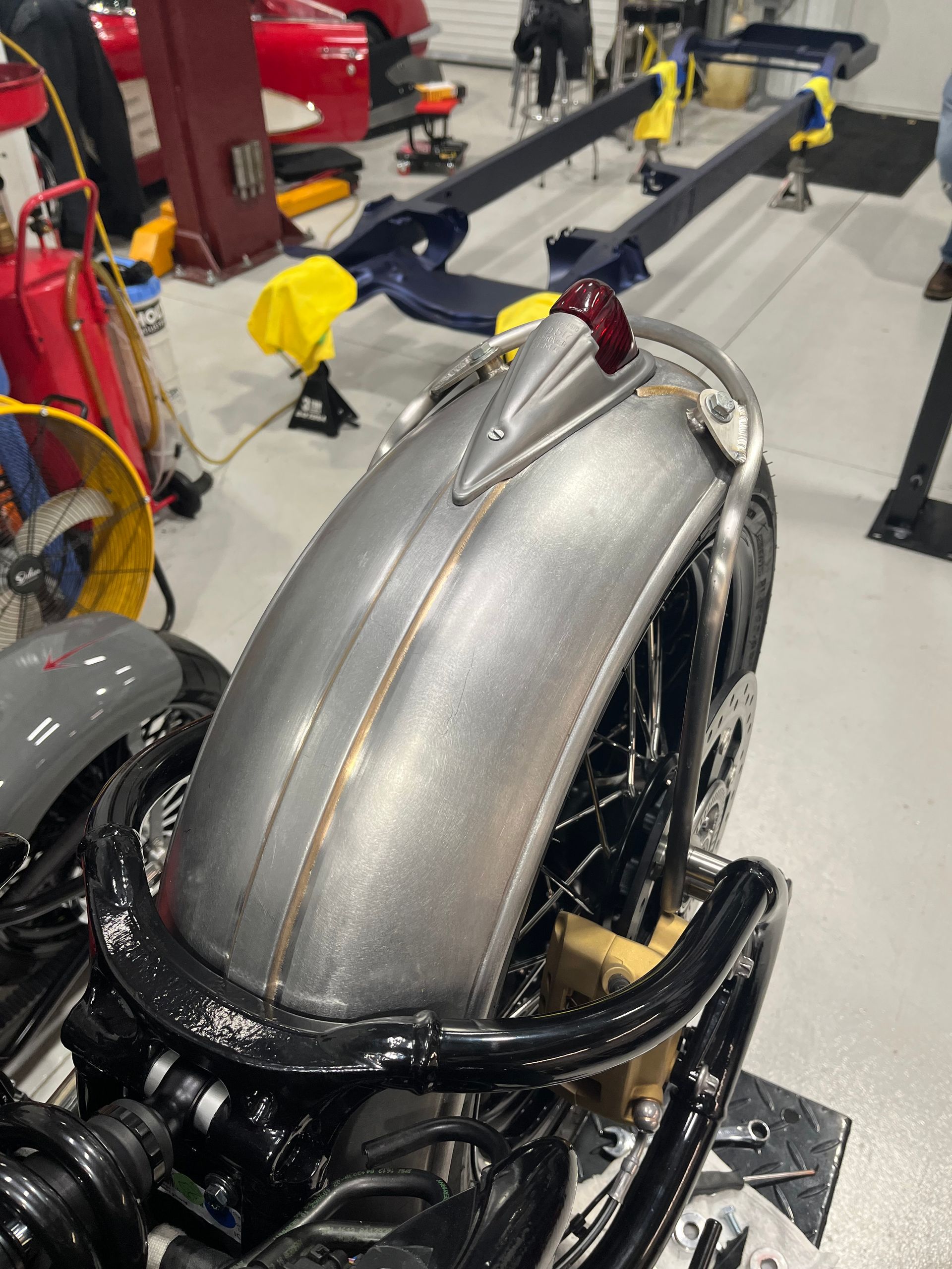 A motorcycle is being worked on in a garage.