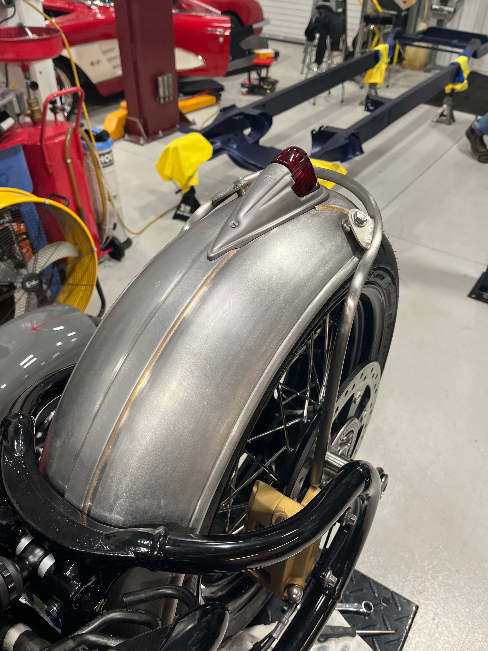 A motorcycle is being worked on in a garage