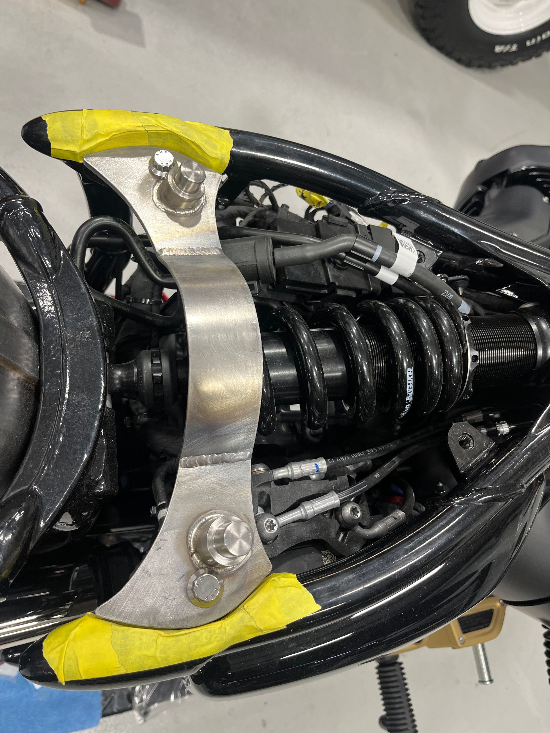 A close up of a motorcycle with a yellow tape on it.