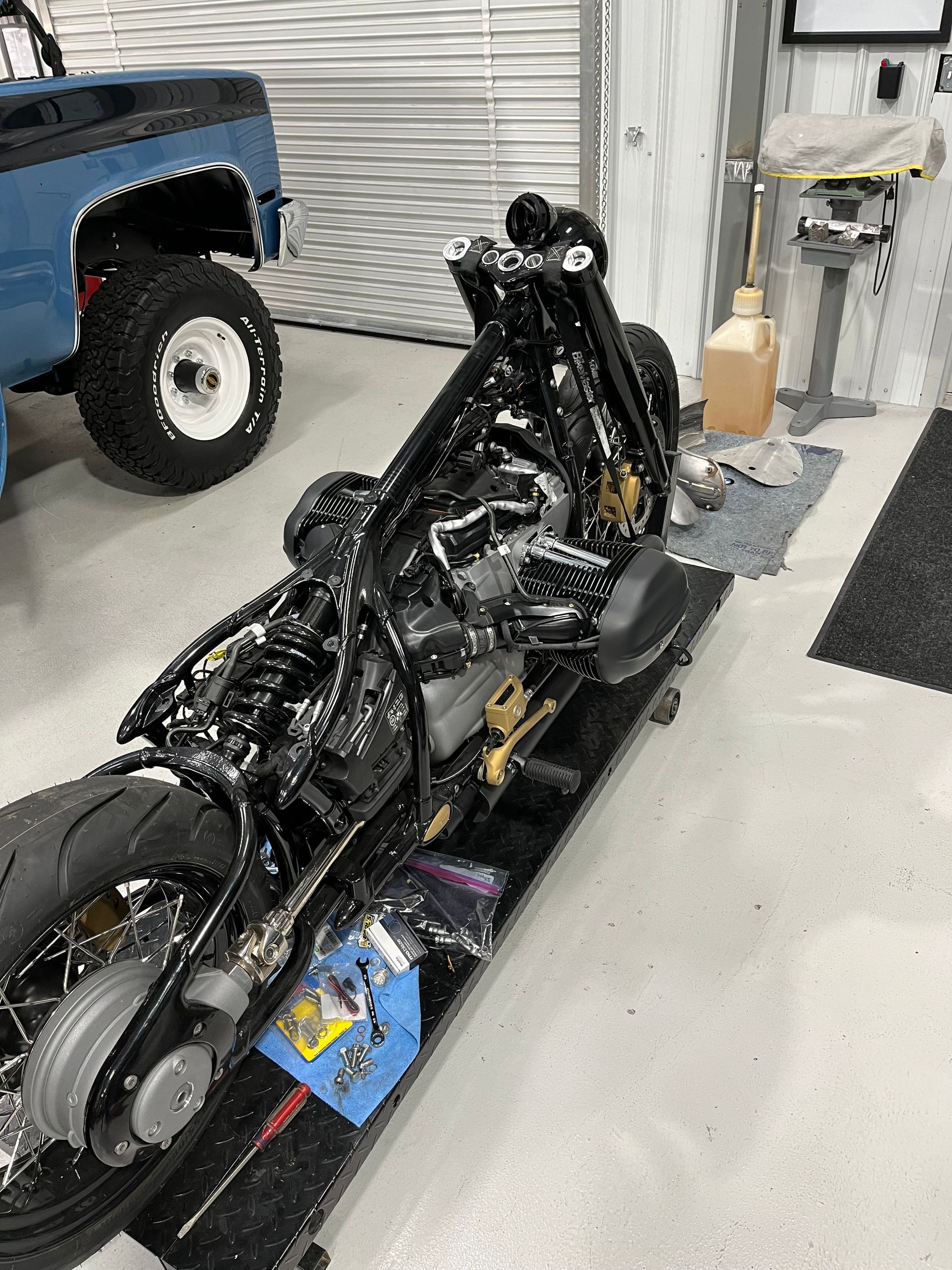 A motorcycle is sitting on a table in a garage.