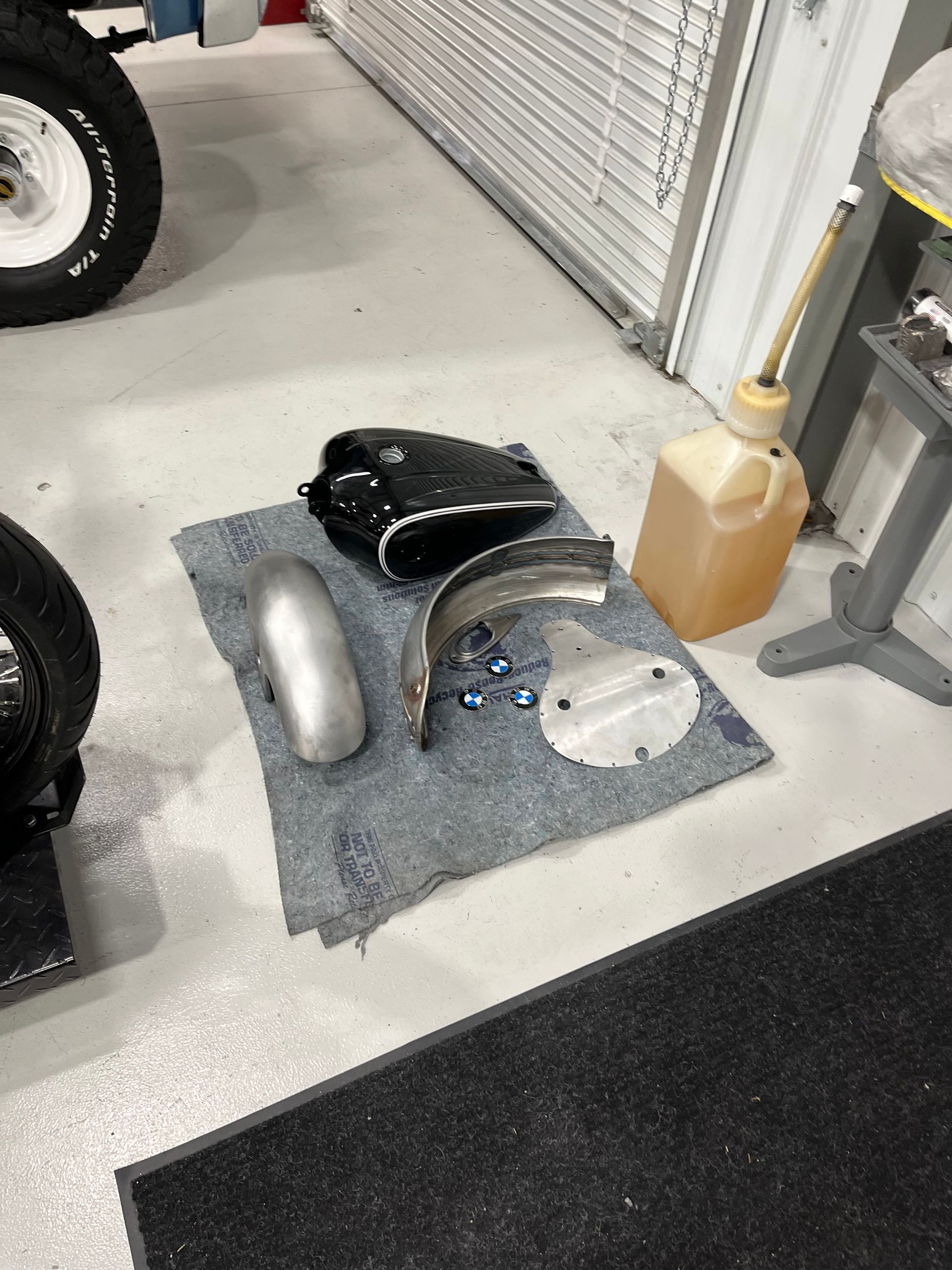 A motorcycle is being worked on in a garage.