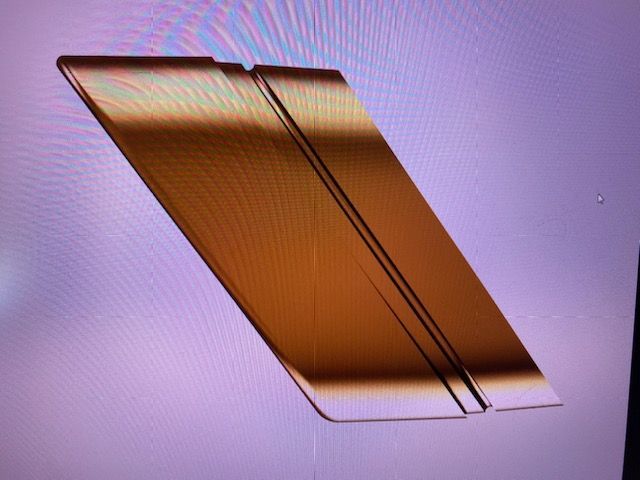 A purple background with a gold object on it