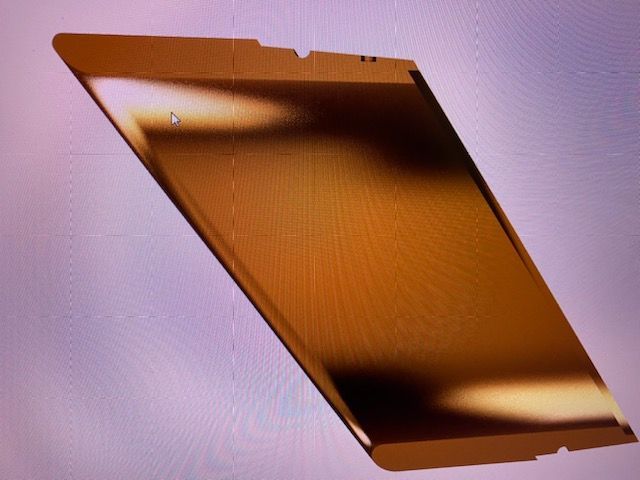 A close up of a gold object on a purple background