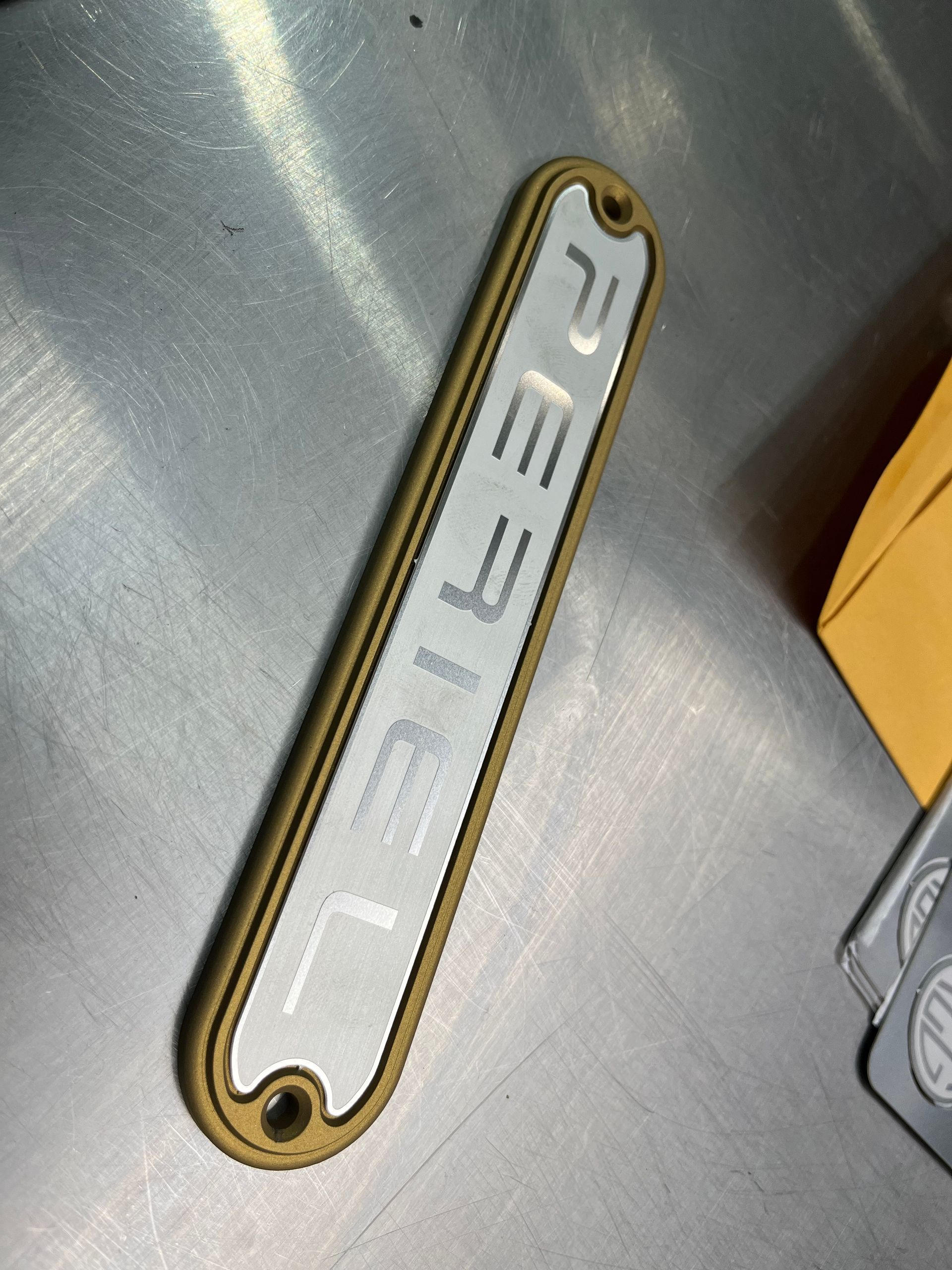 A metal plate with the word rebel on it