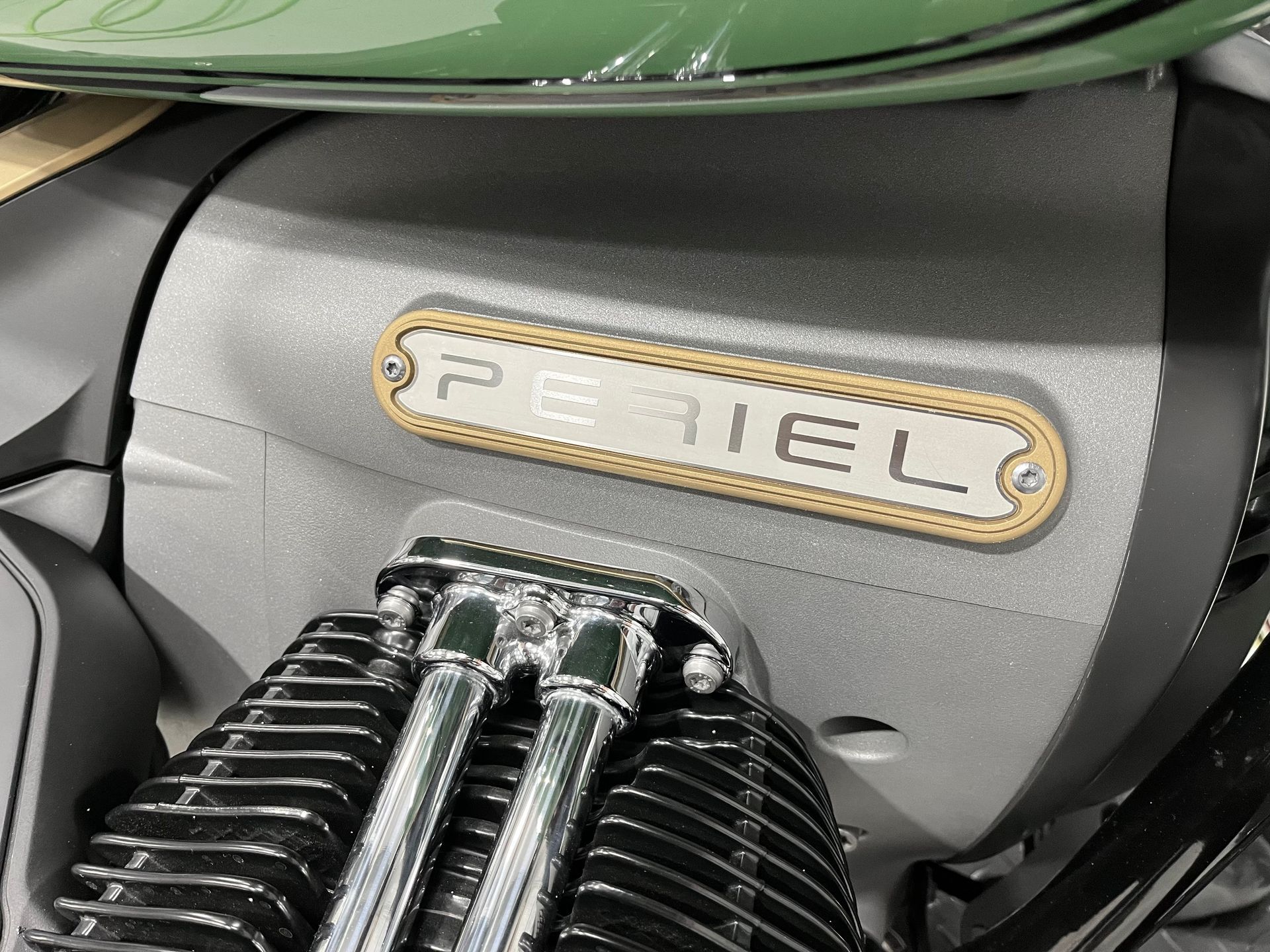 A close up of a motorcycle engine with the word periel on it