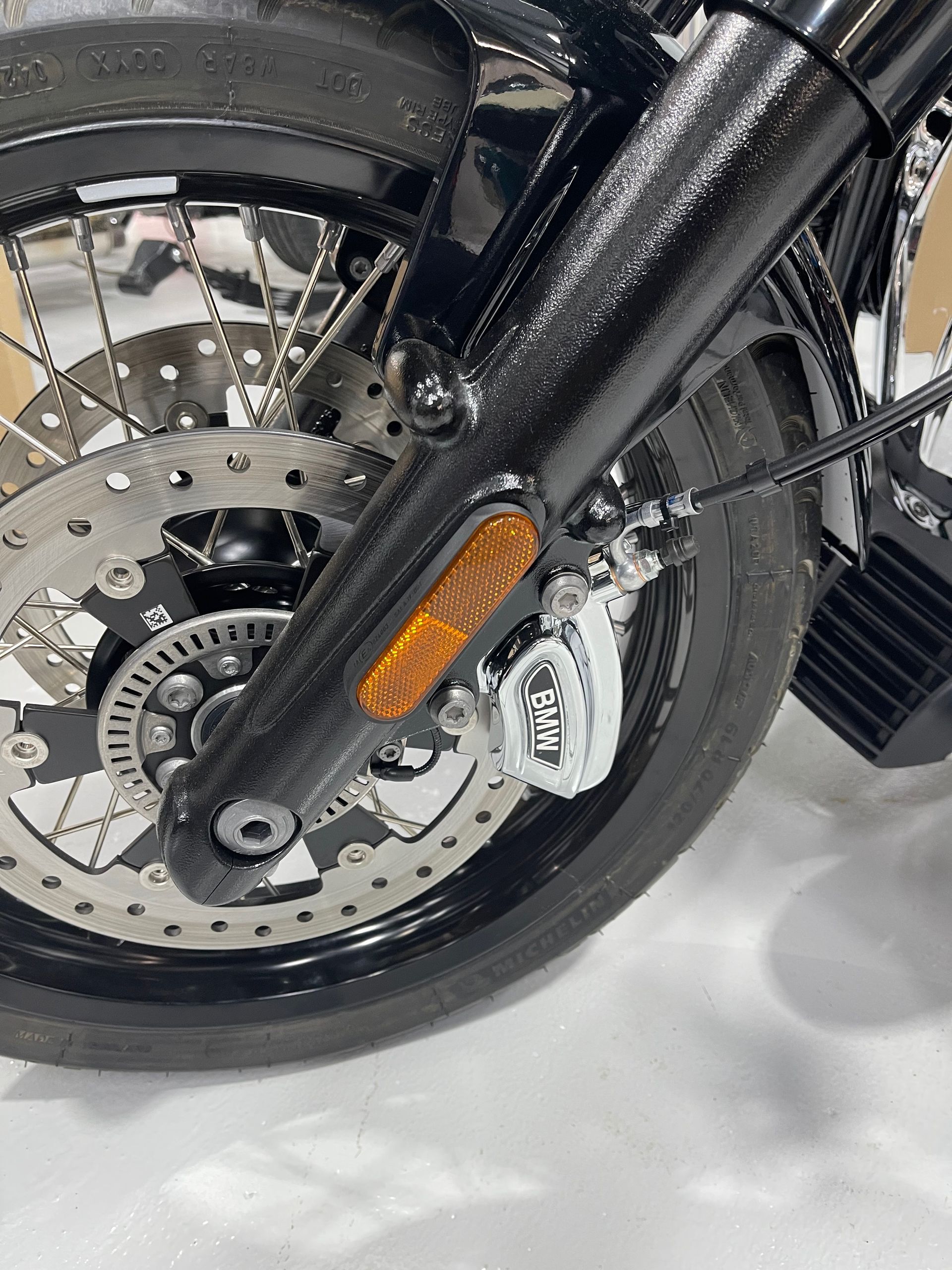 A close up of the front wheel of a motorcycle.