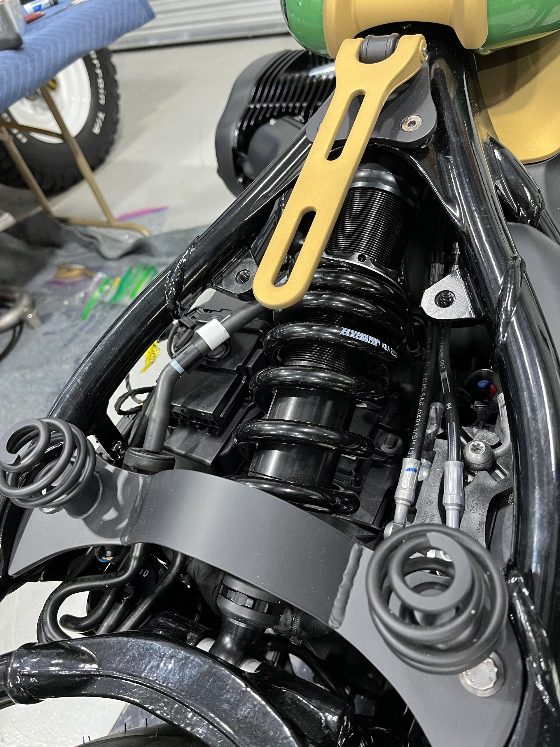 A close up of a motorcycle engine with a yellow wrench on it