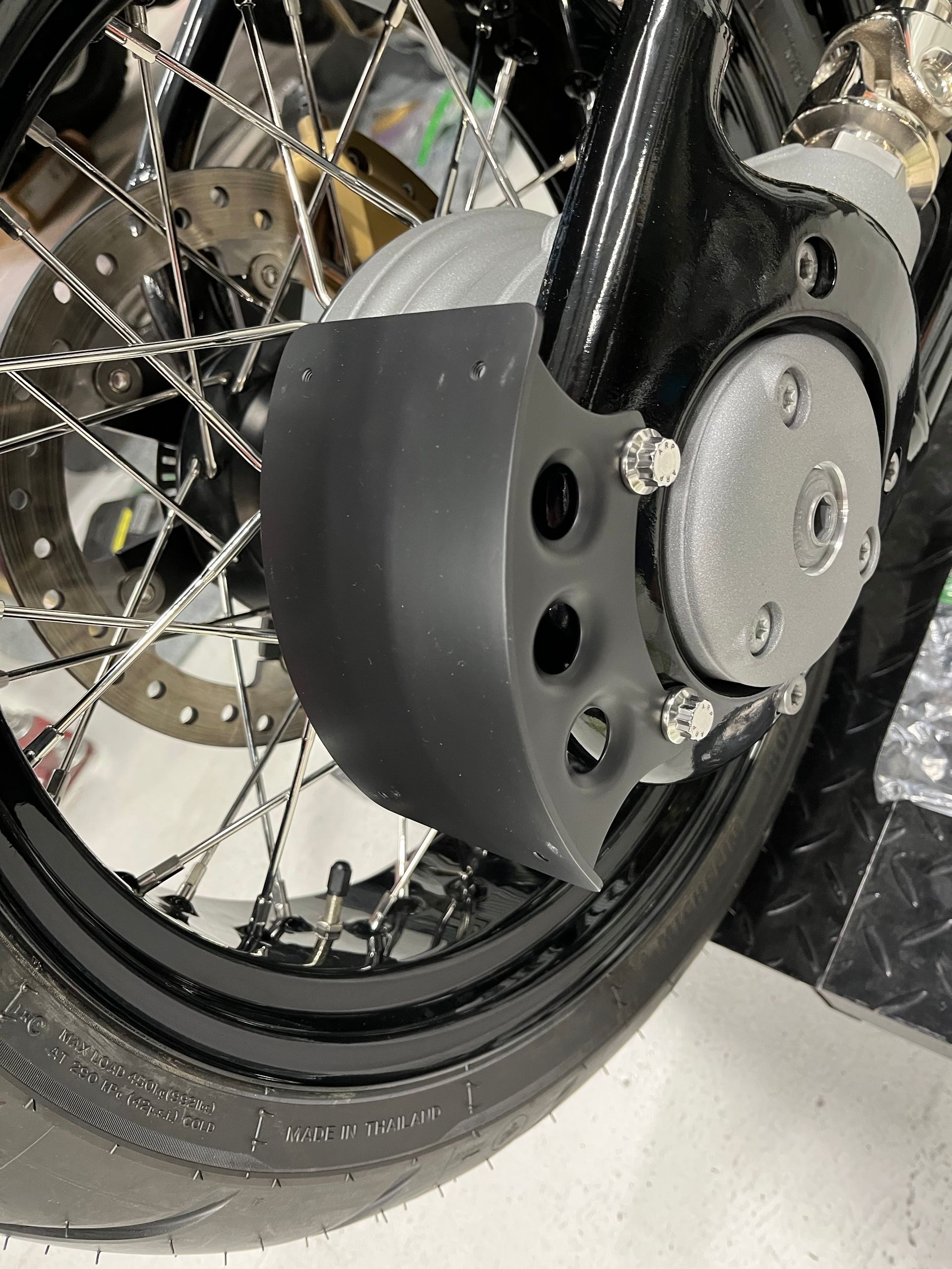 A close up of the front wheel of a motorcycle