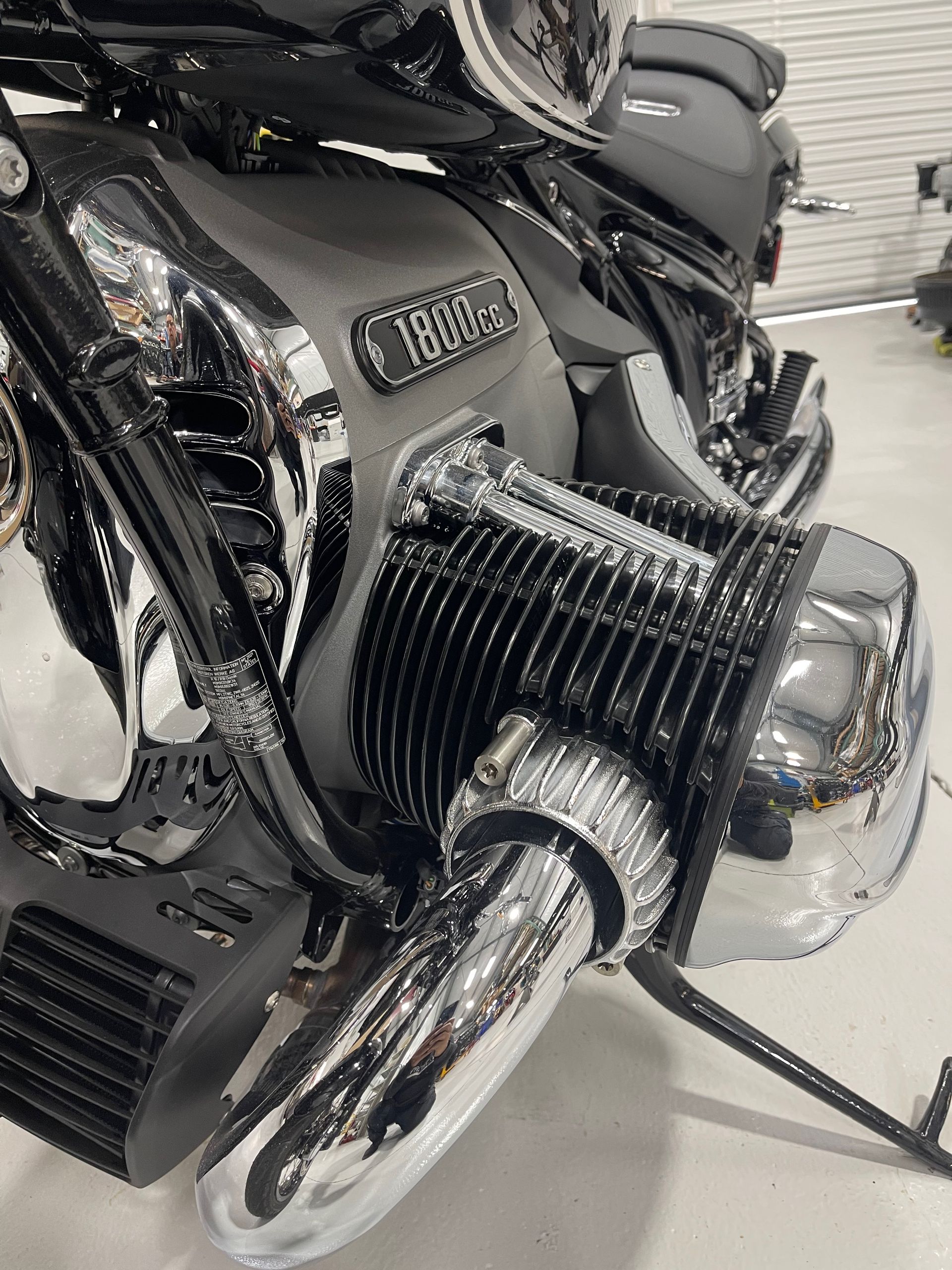 A close up of a motorcycle engine in a garage.