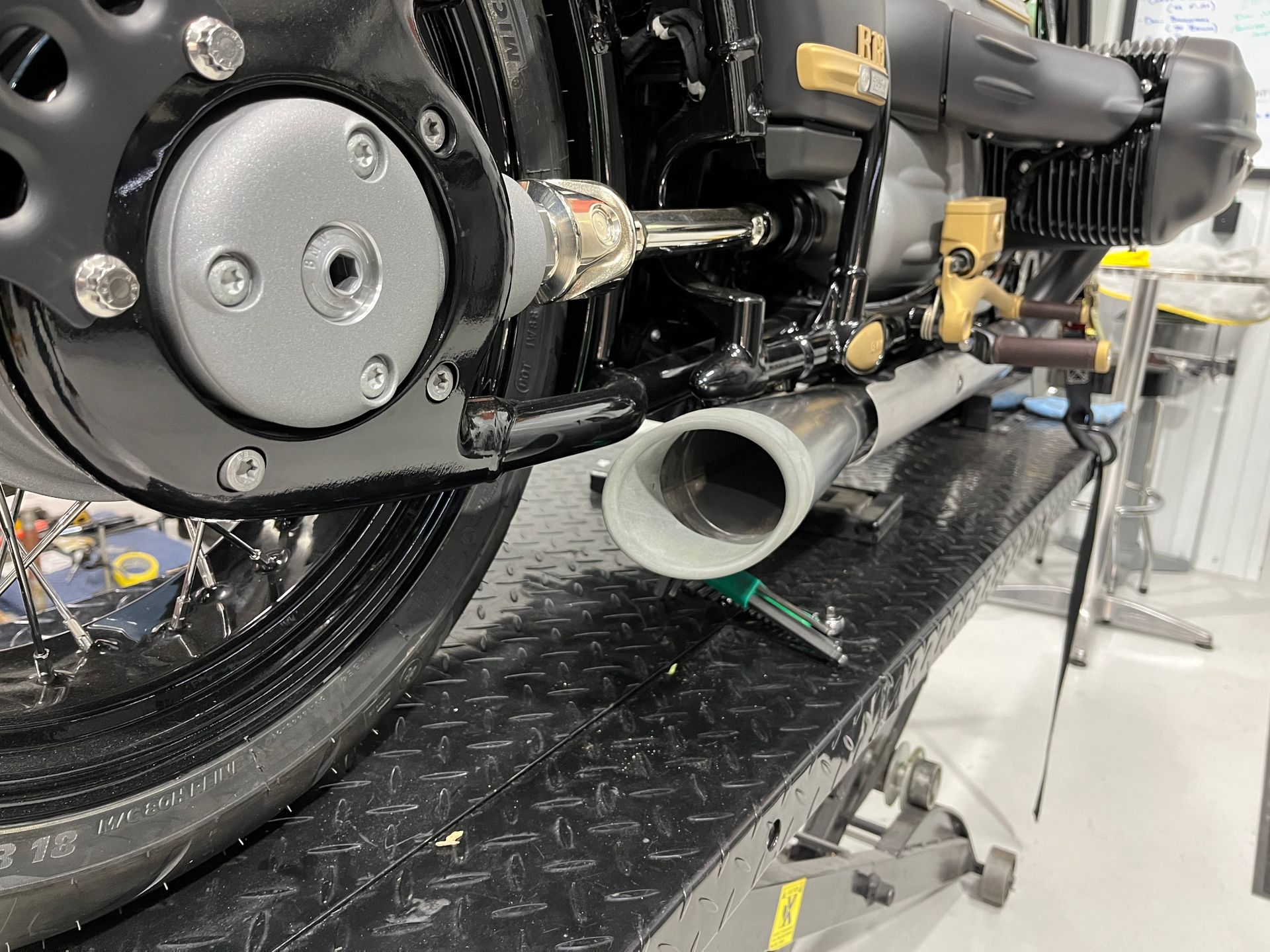 A motorcycle is being worked on in a garage.