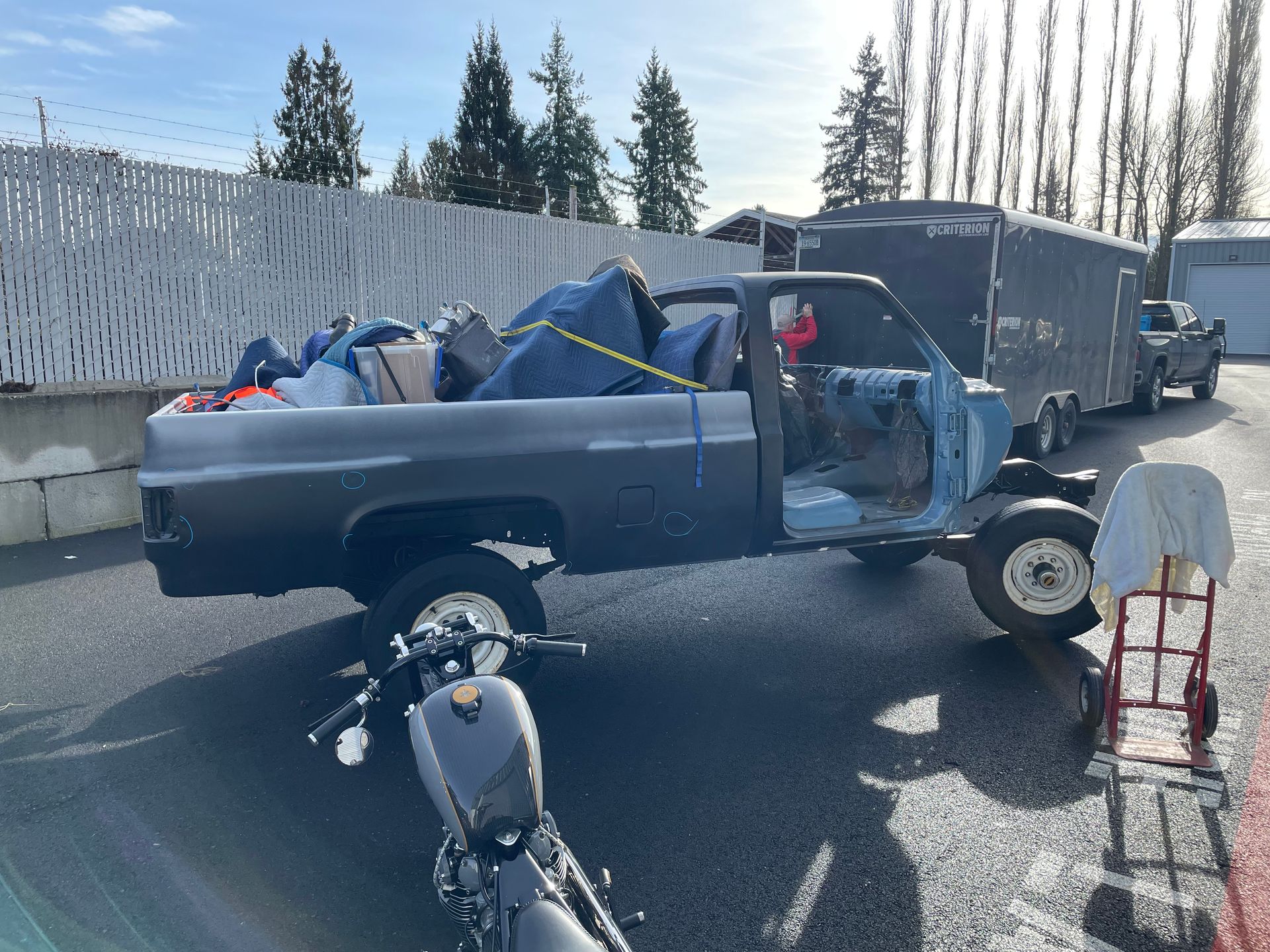 A truck with a motorcycle in the back of it