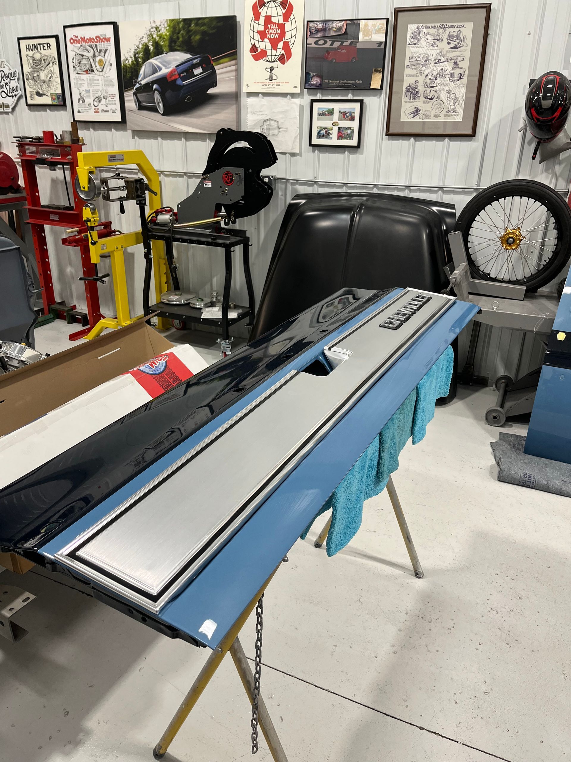 A car wing is sitting on a table in a garage.