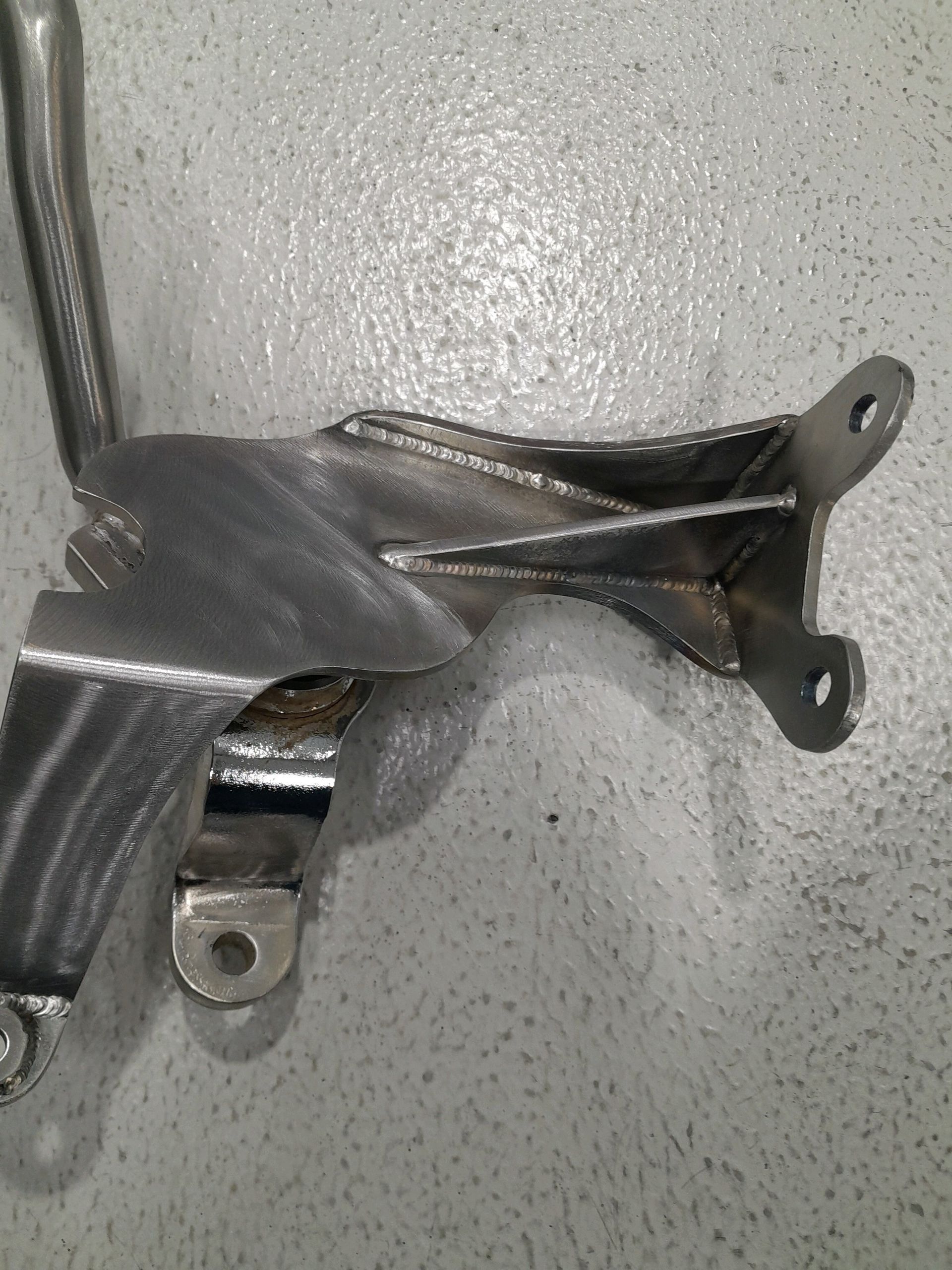 A piece of metal is sitting on a white surface.