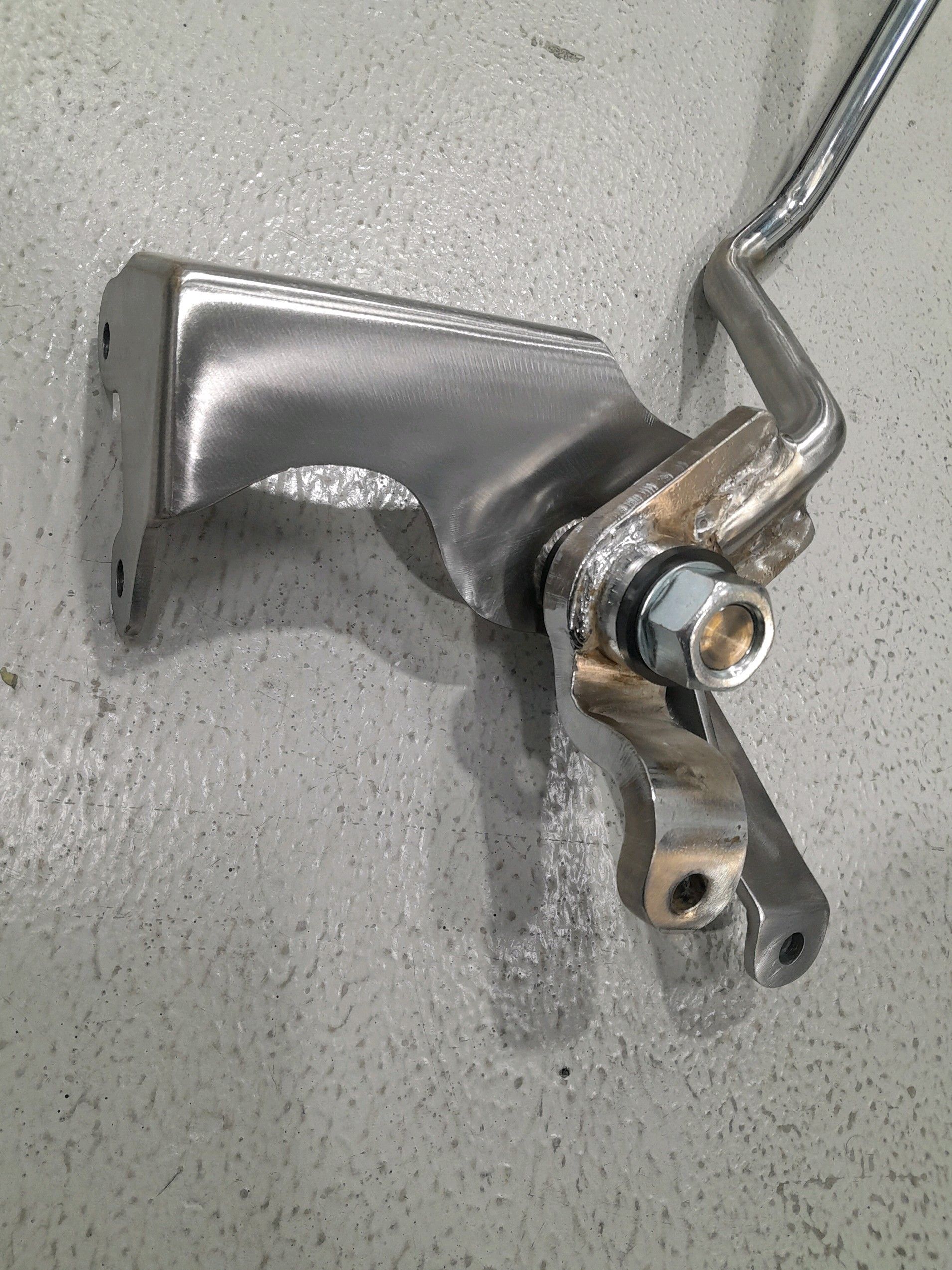 A close up of a metal object on a concrete surface.