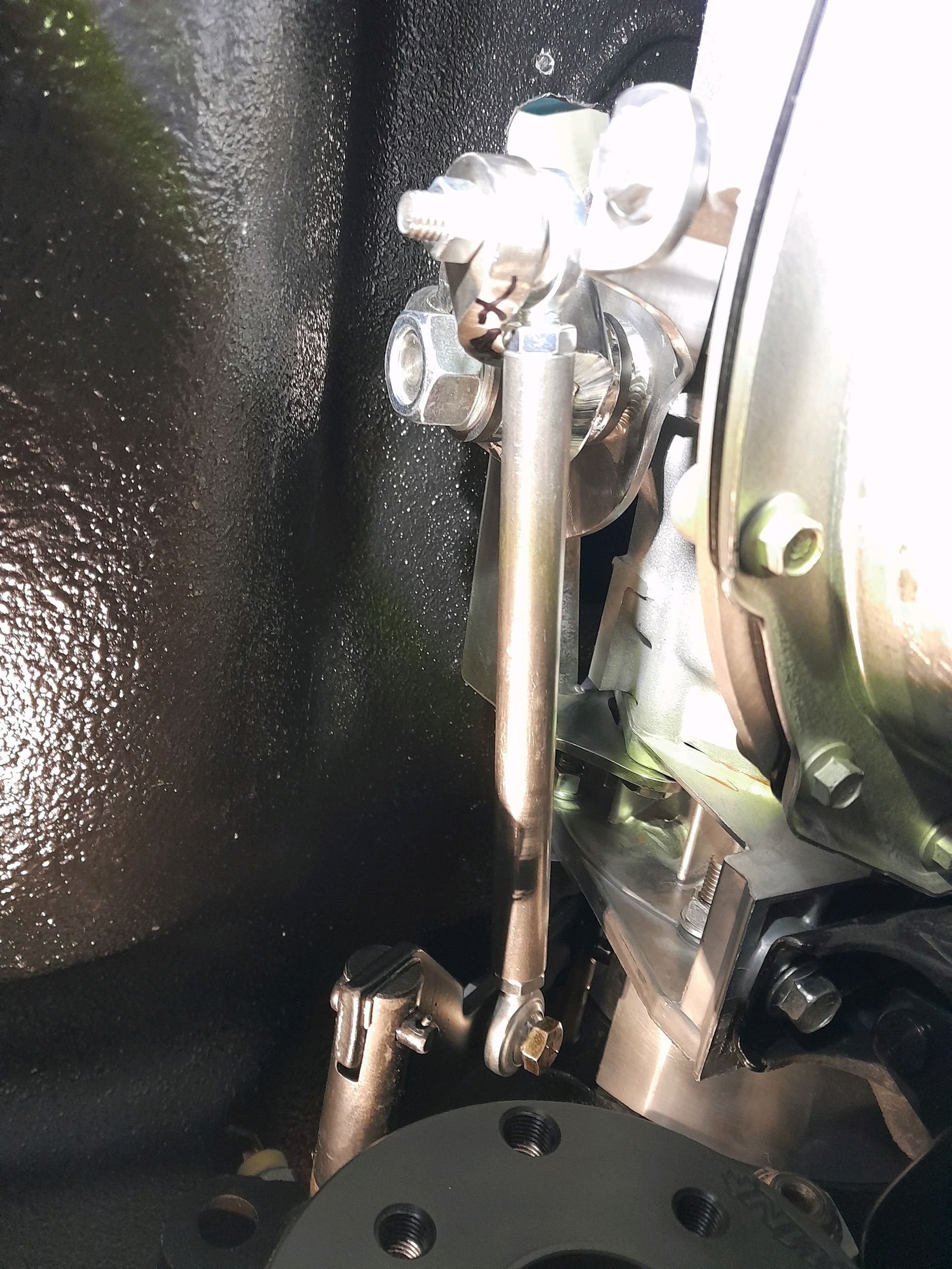 A close up of a metal object with a black background