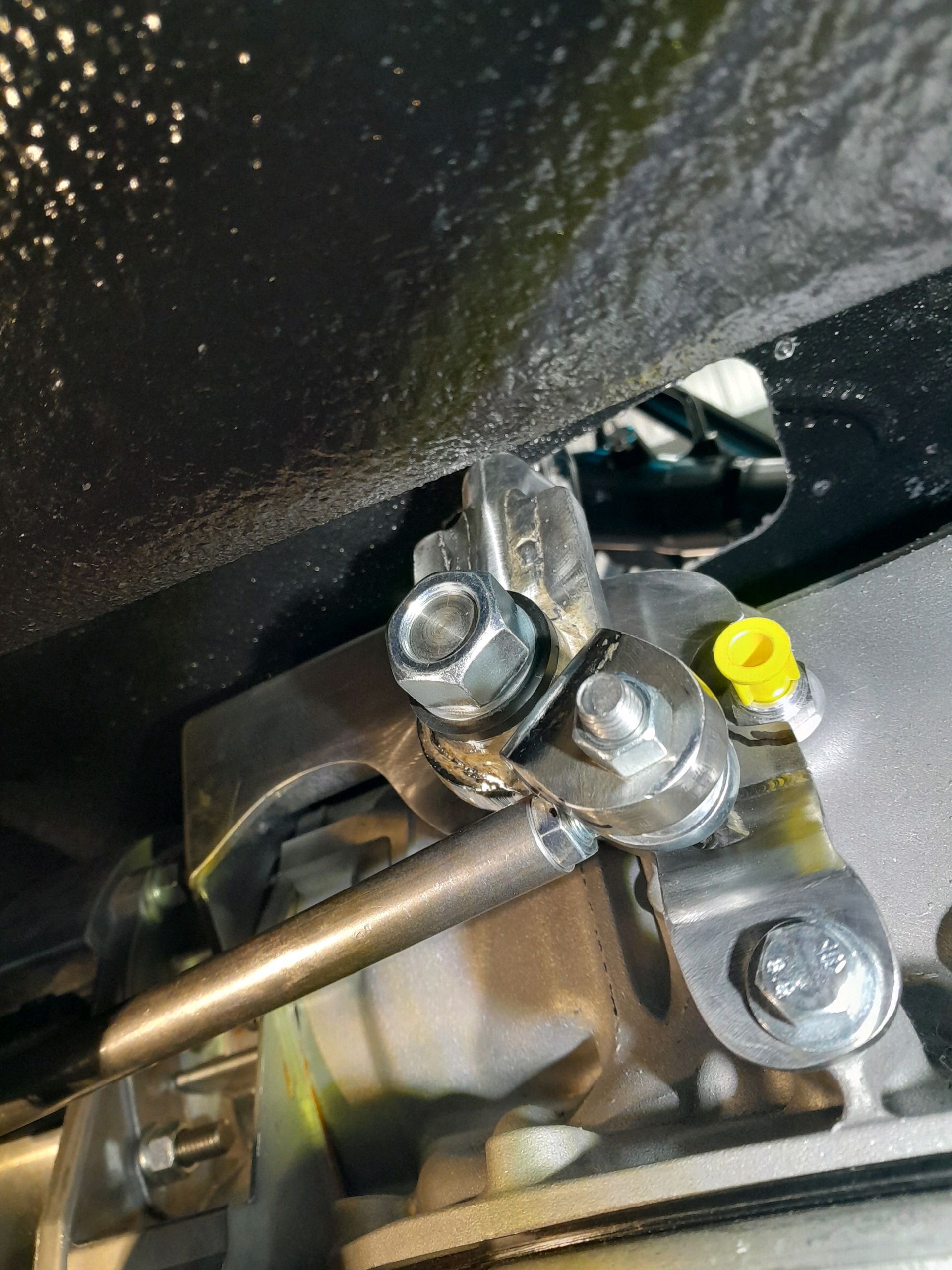 A close up of a metal object with a yellow cap on it.