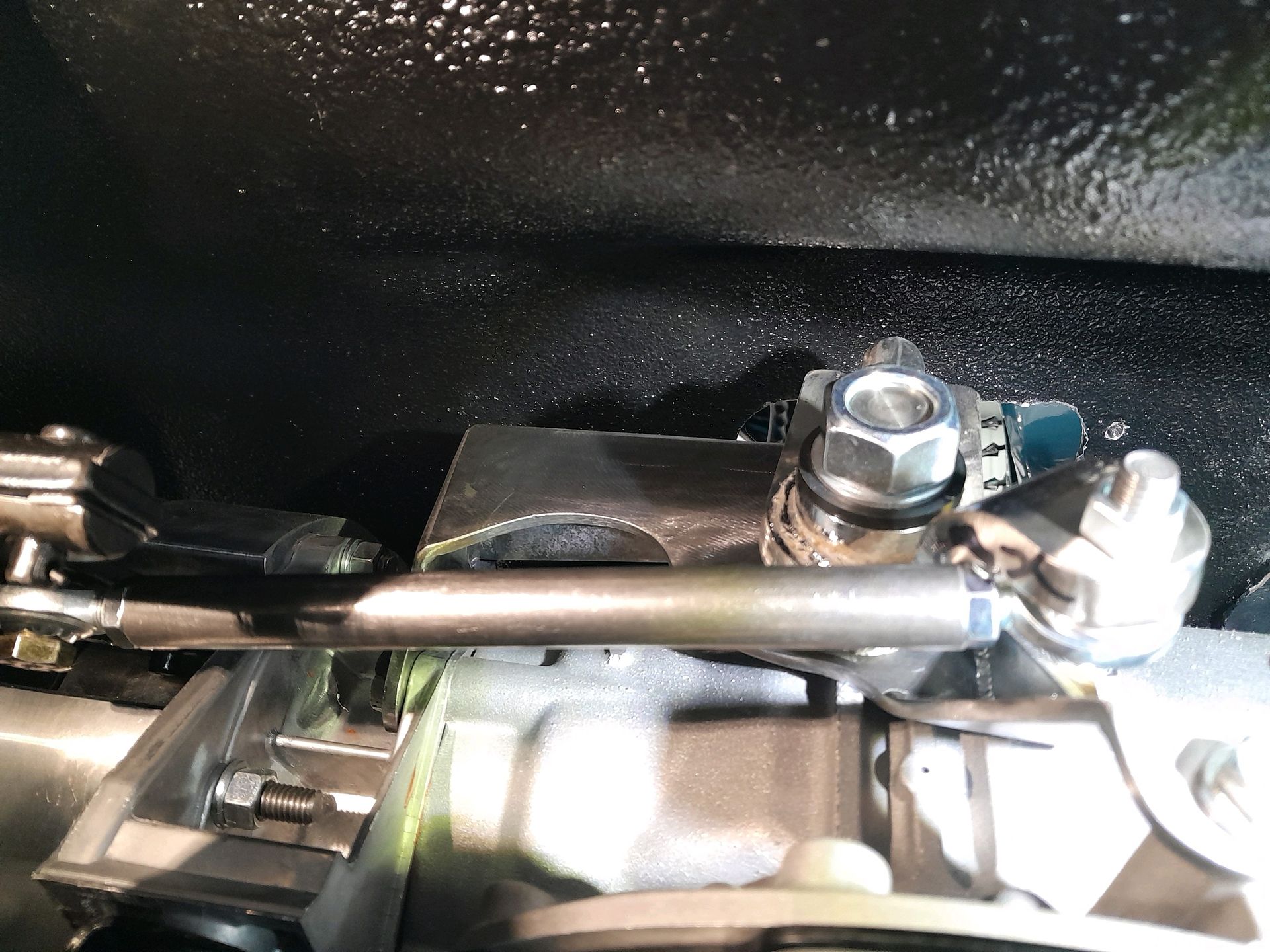 A close up of a metal object with a nut on it