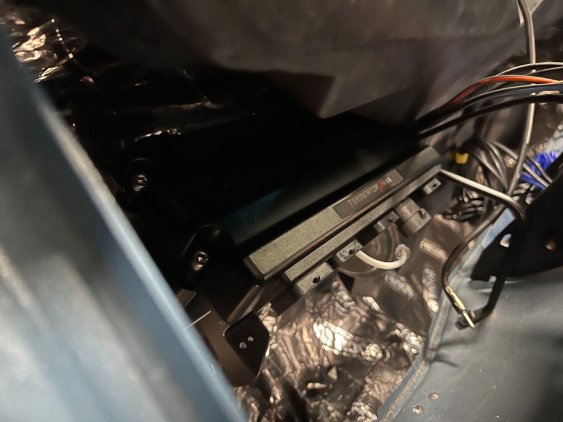 A black box is sitting in the trunk of a car.