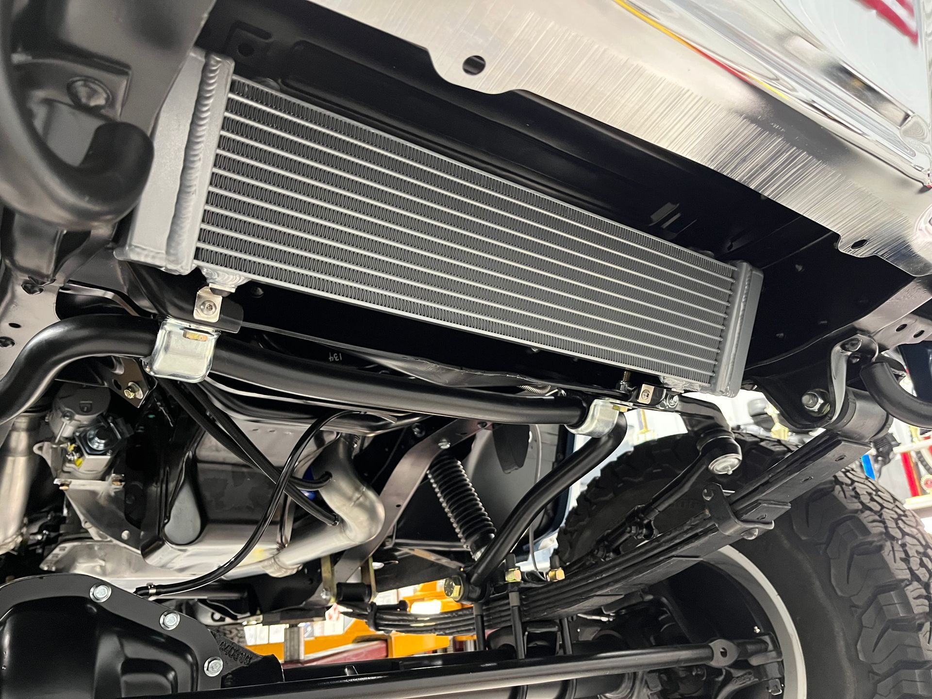 A close up of a radiator on the underside of a car.