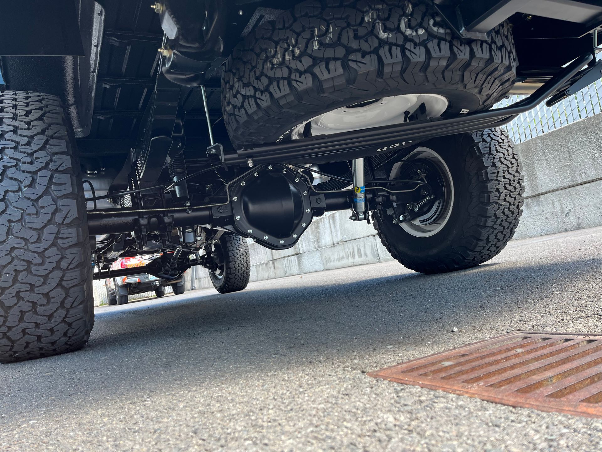 The rear end of a truck is parked on the side of the road.