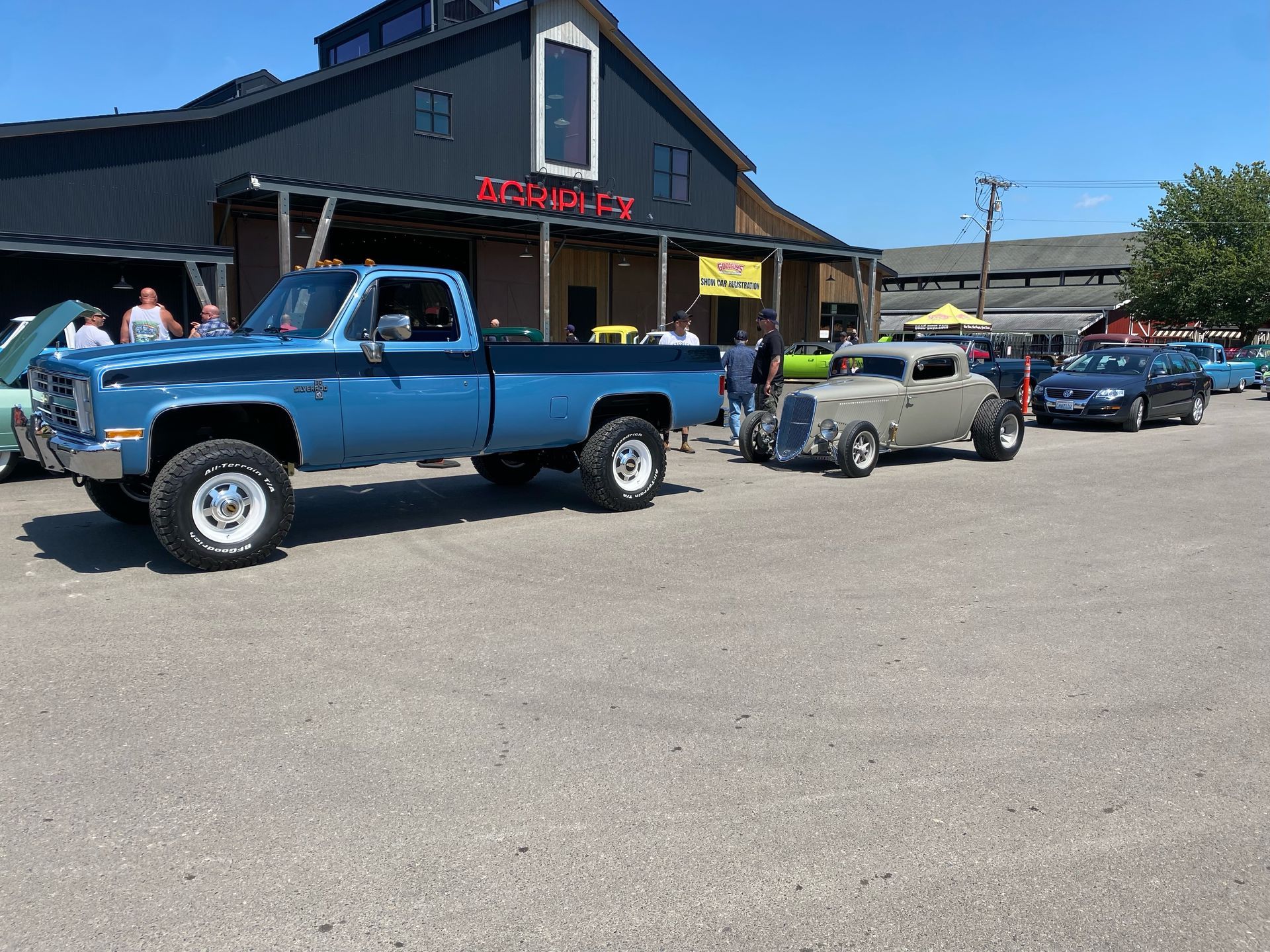 A blue truck is parked in front of a building.