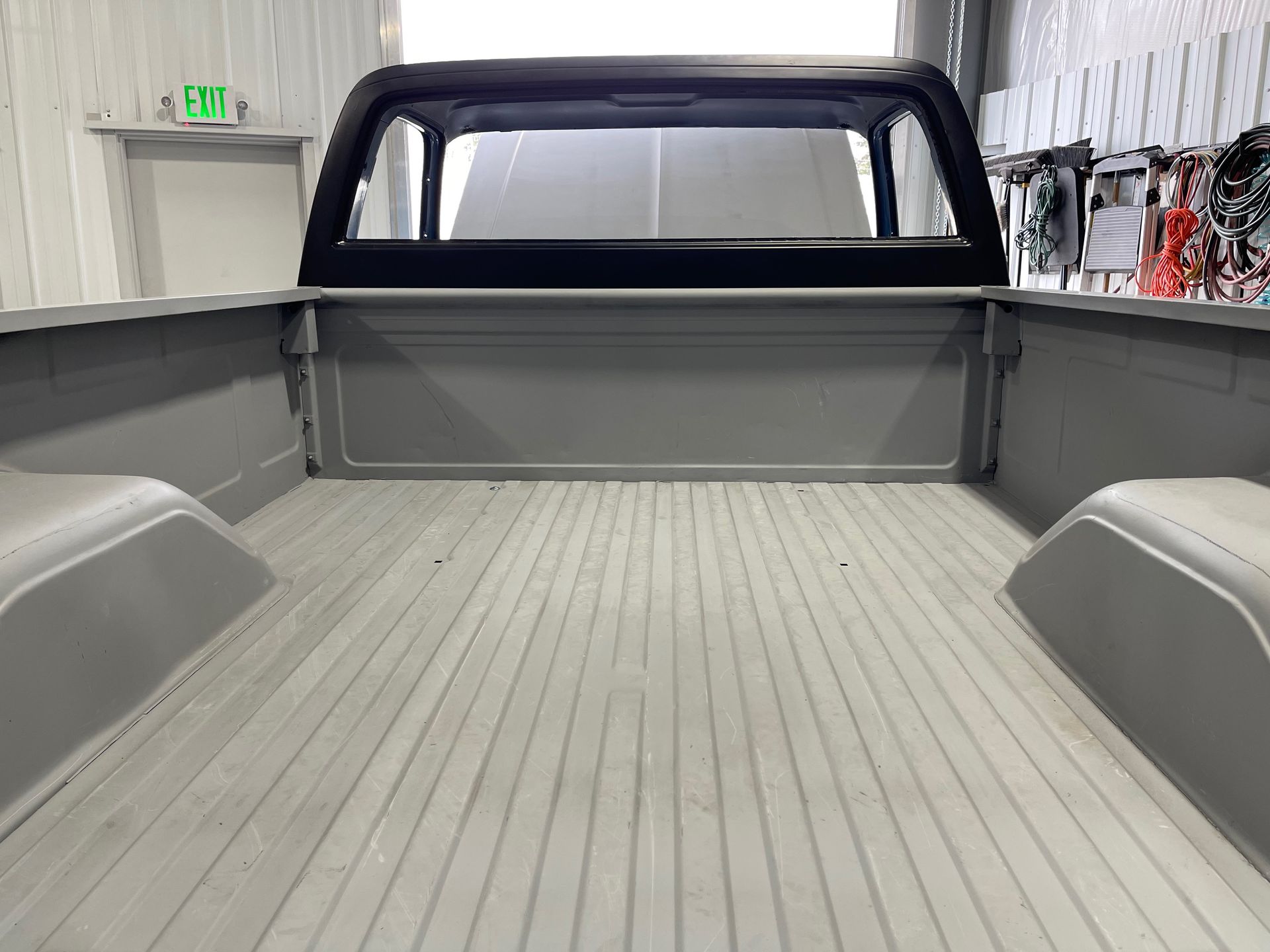 The back of a truck with a window and a roof rack.