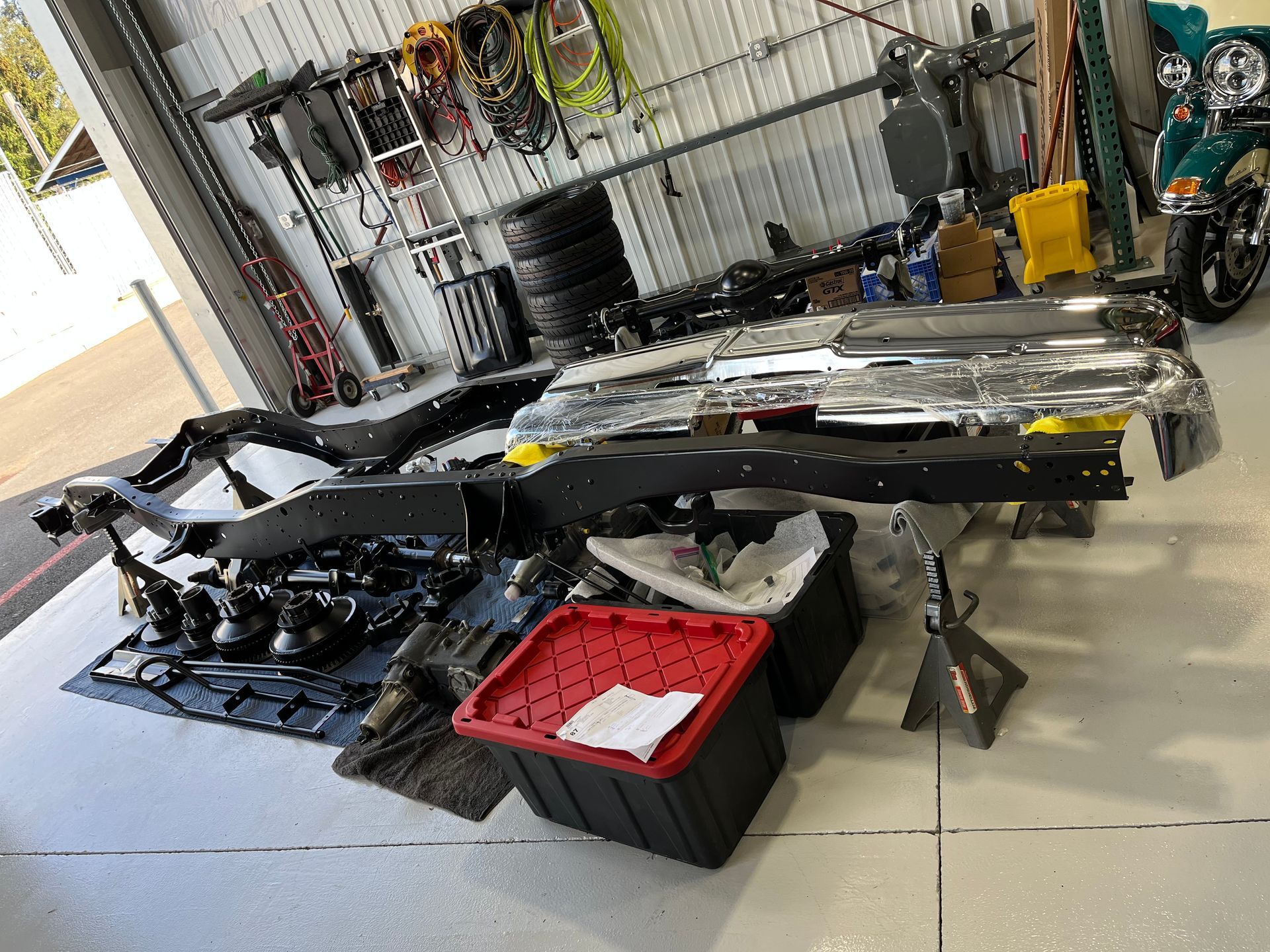 A motorcycle is being worked on in a garage.