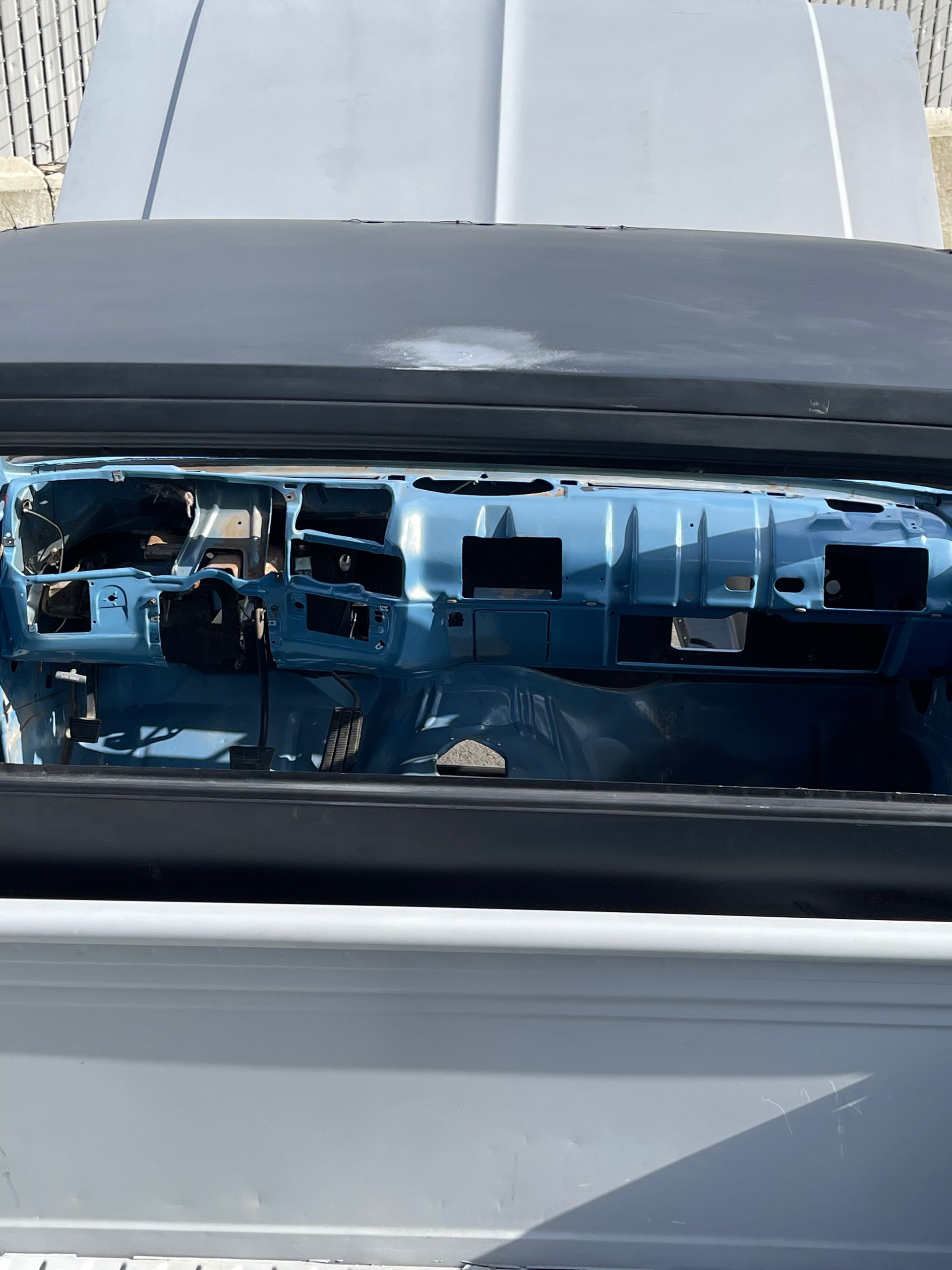 A close up of a car 's windshield with the hood open.