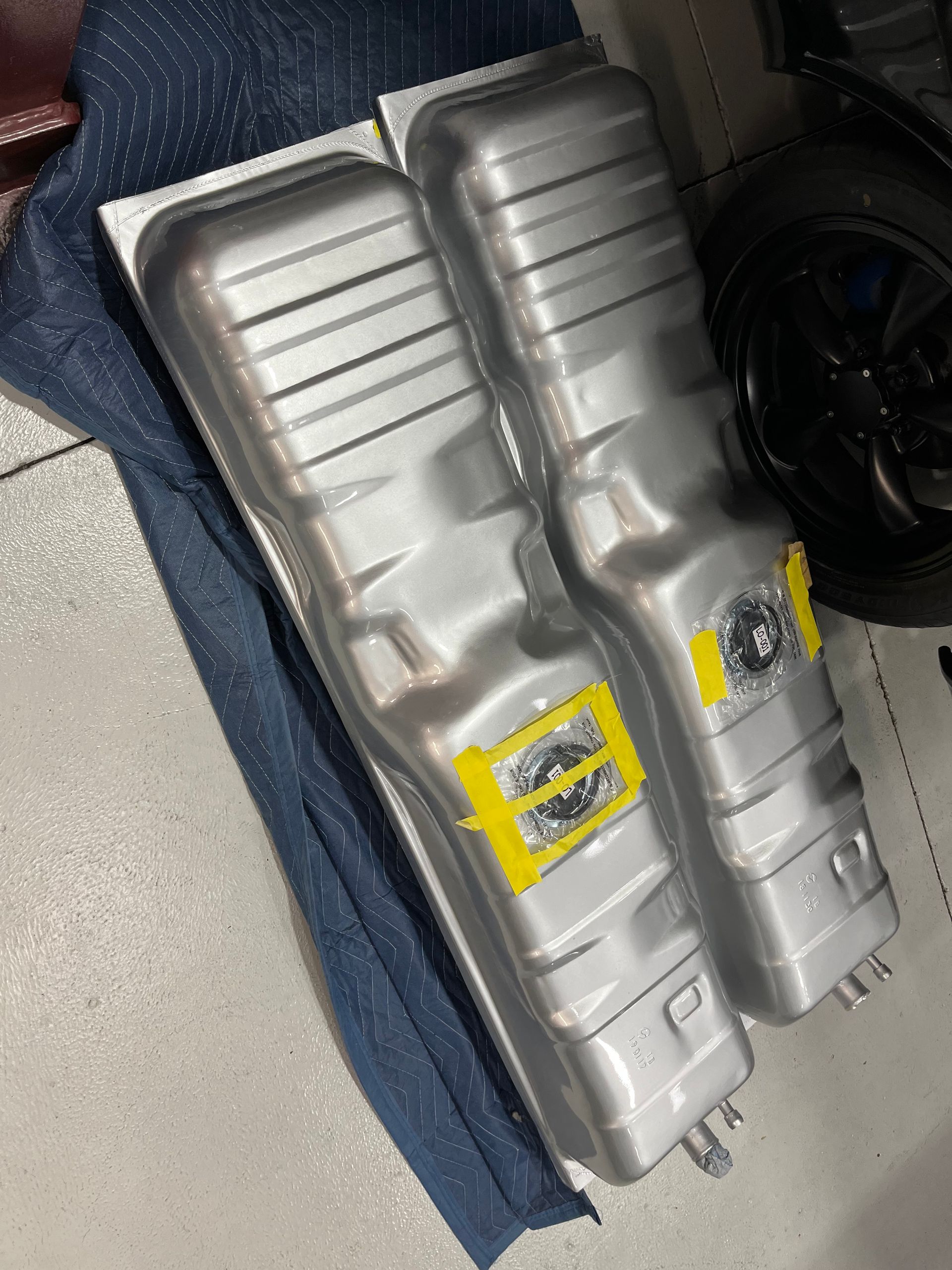 Two fuel tanks are sitting on top of each other on a table.