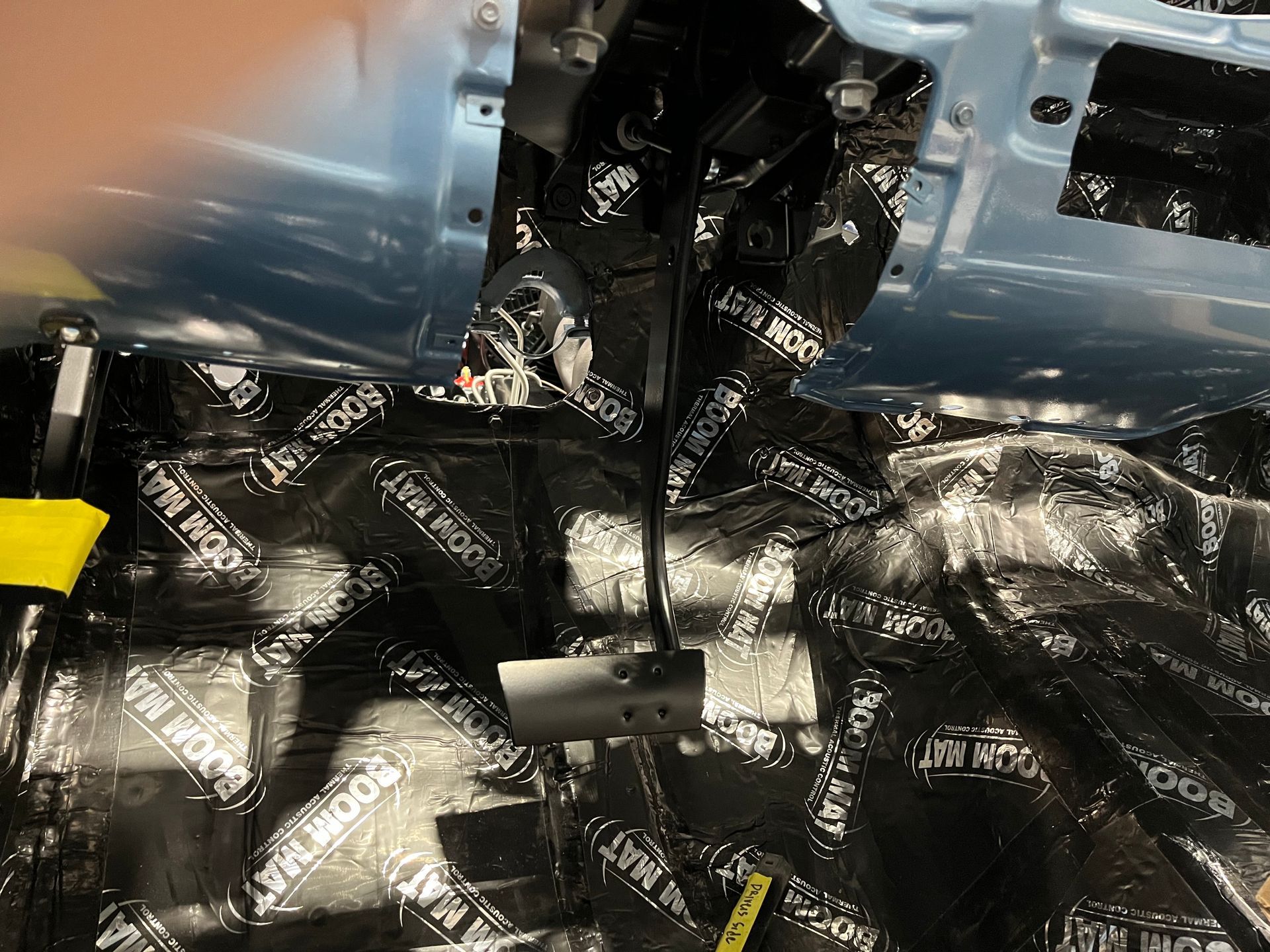 A close up of a piece of foam on the floor of a car.