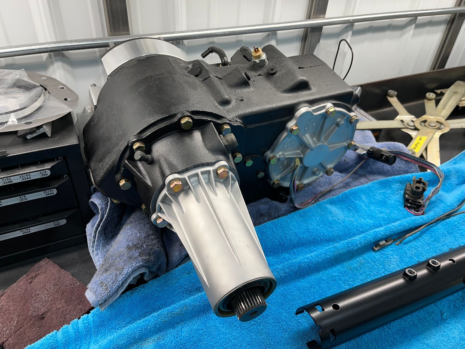 A motor is sitting on top of a blue towel on a table.