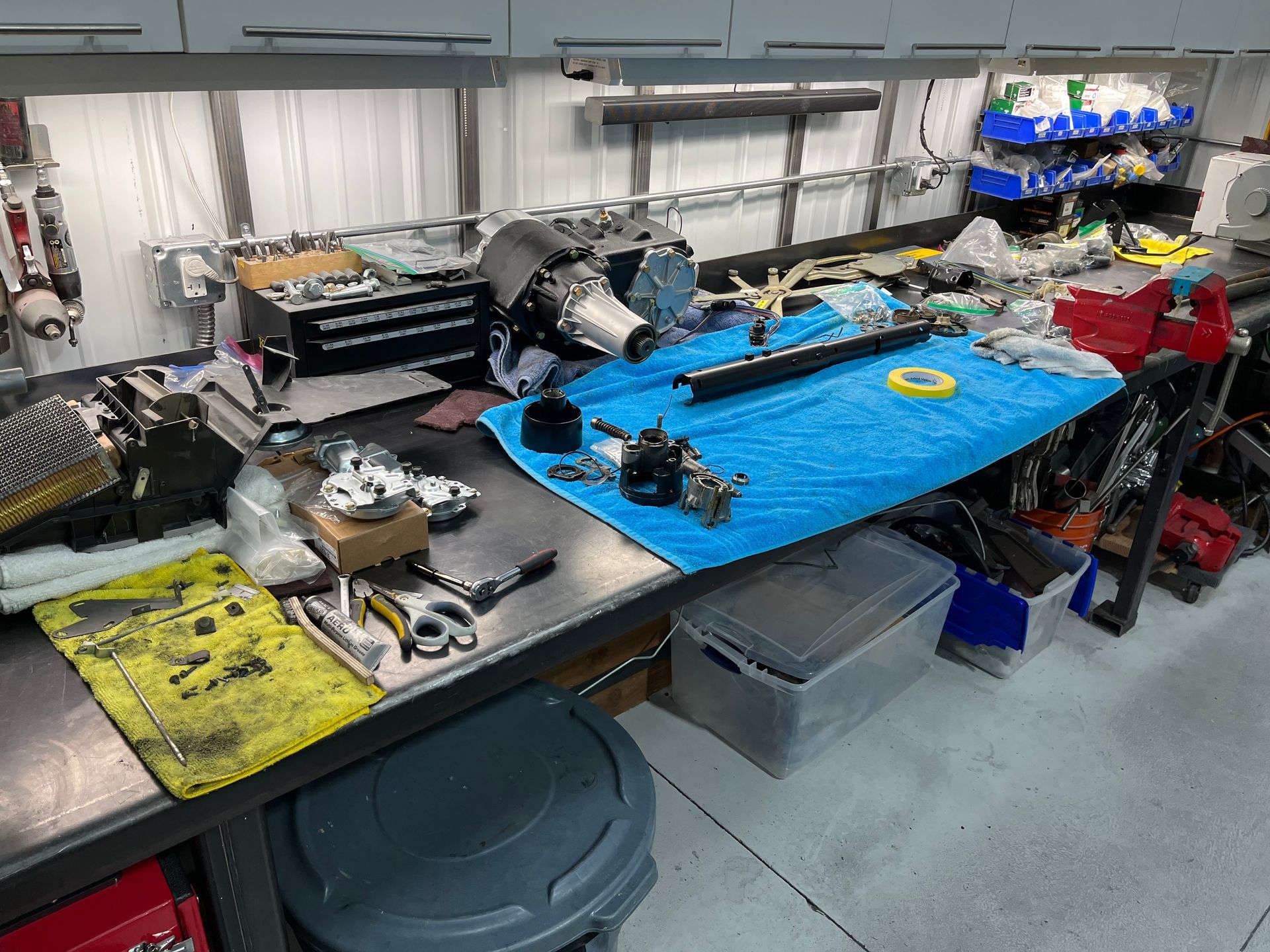 A workbench in a garage with a blue towel on it.