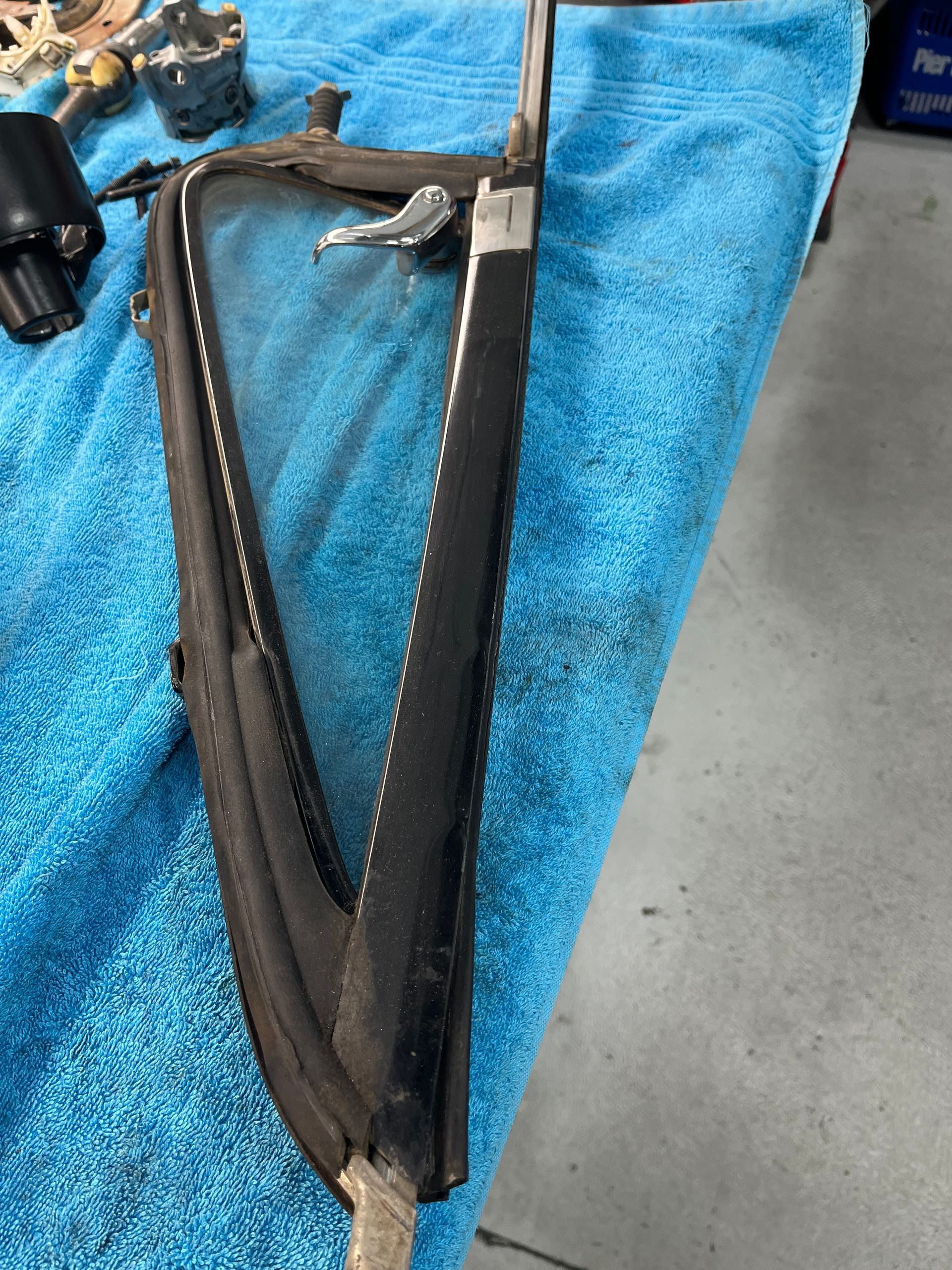 A window is sitting on top of a blue towel.