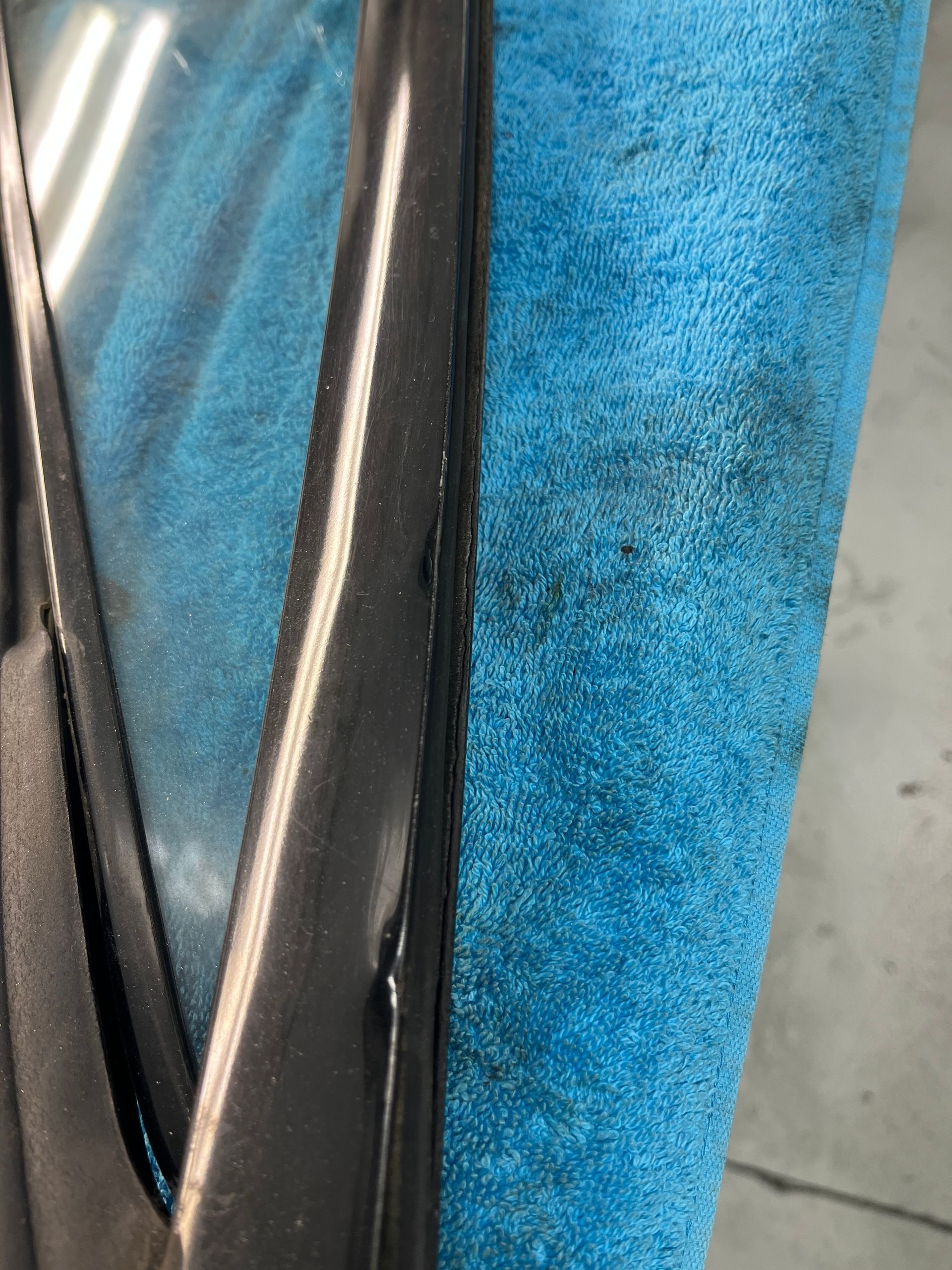 A close up of a car door on a blue towel.
