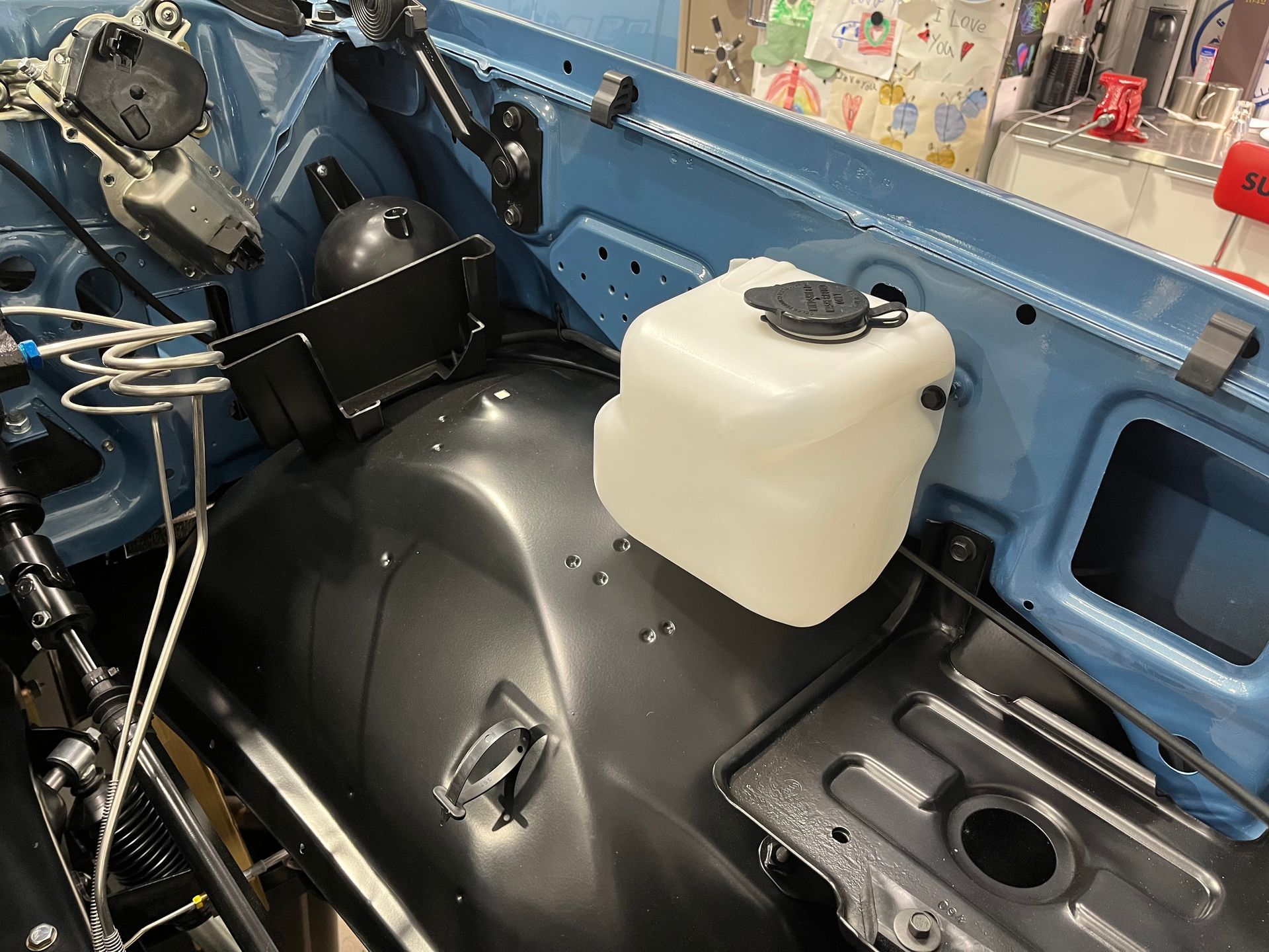 A bottle of water is sitting inside of a car.