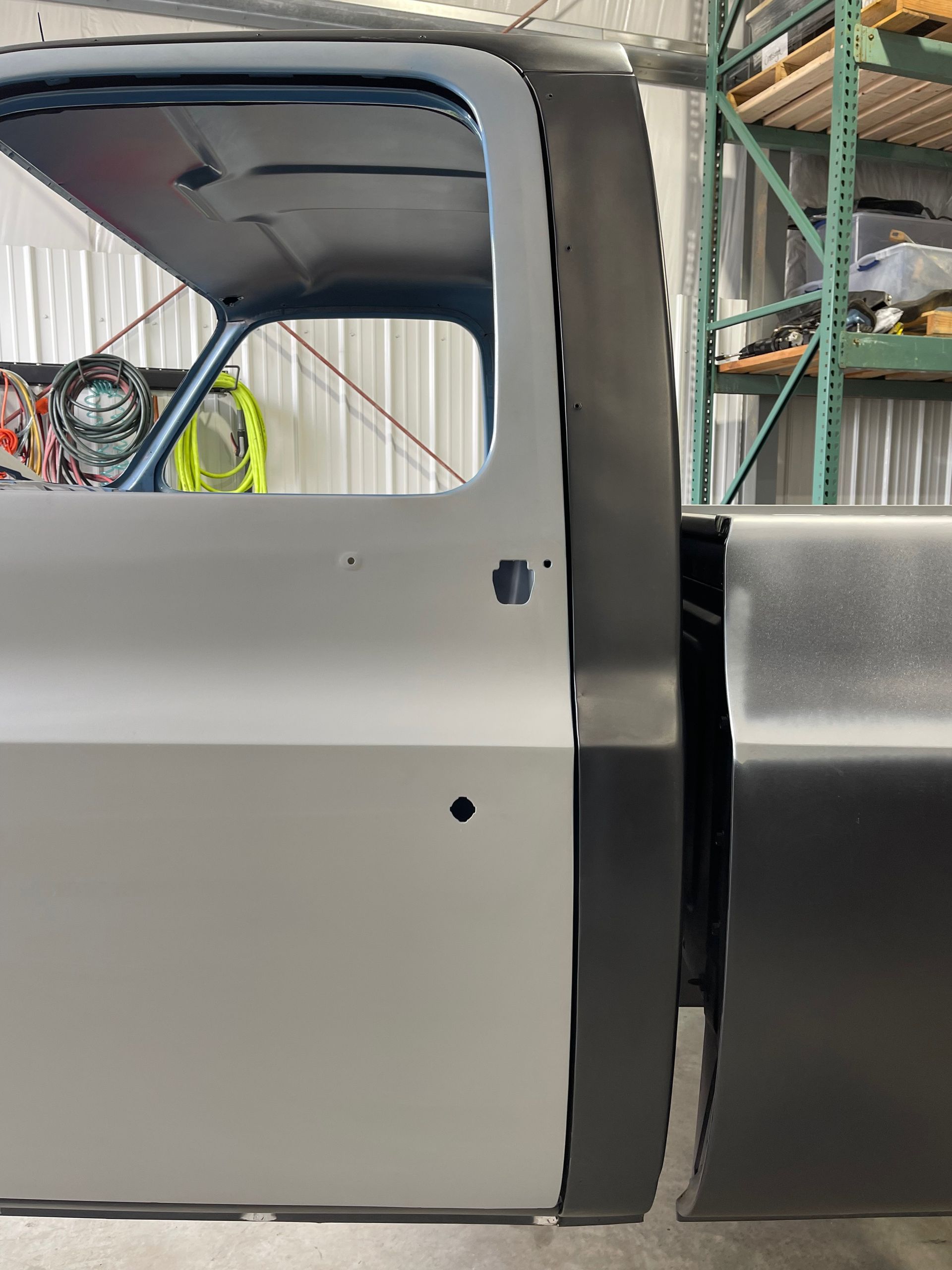 A close up of a truck door in a garage.