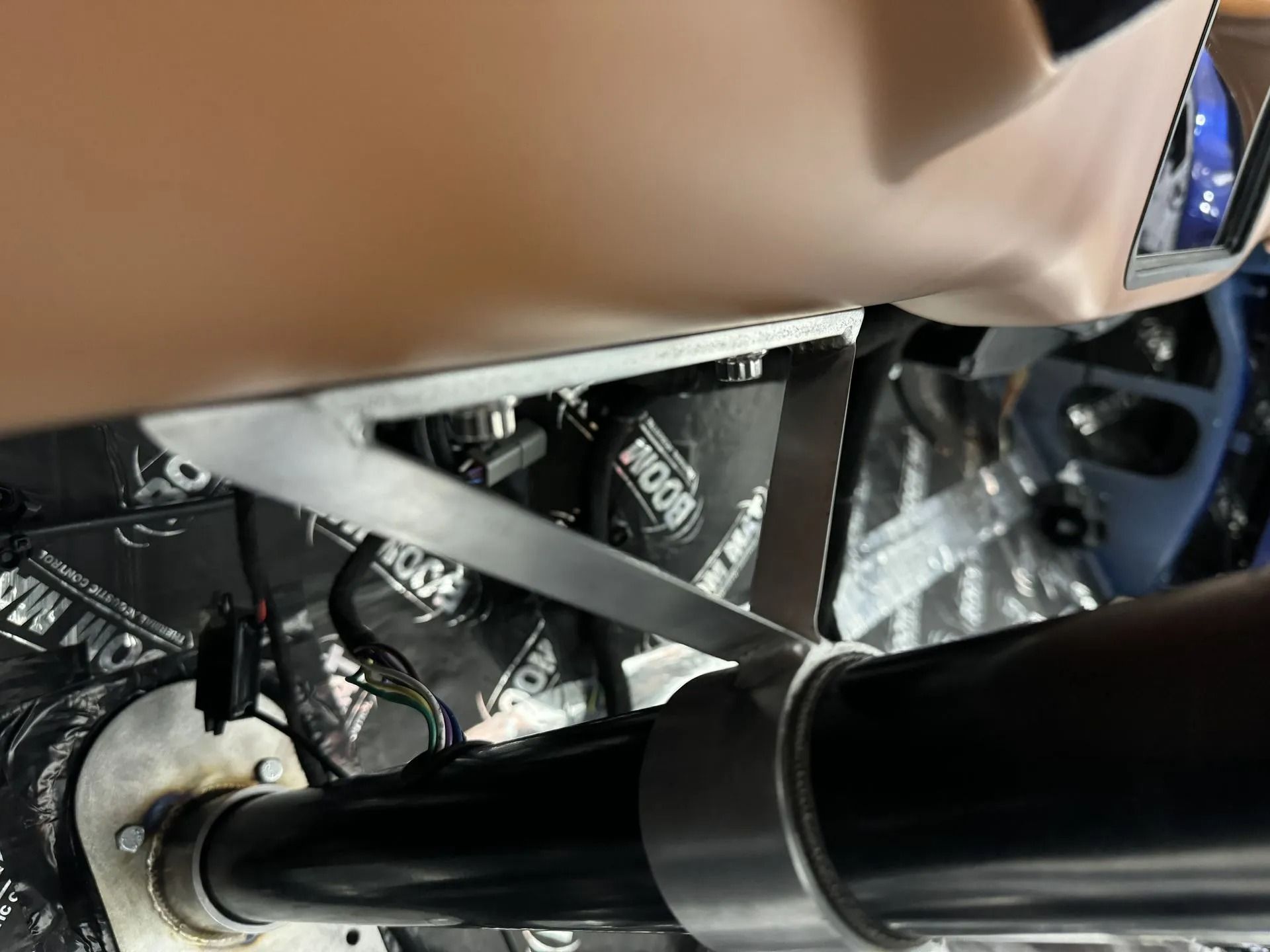 A close up of a pipe with a hose attached to it.