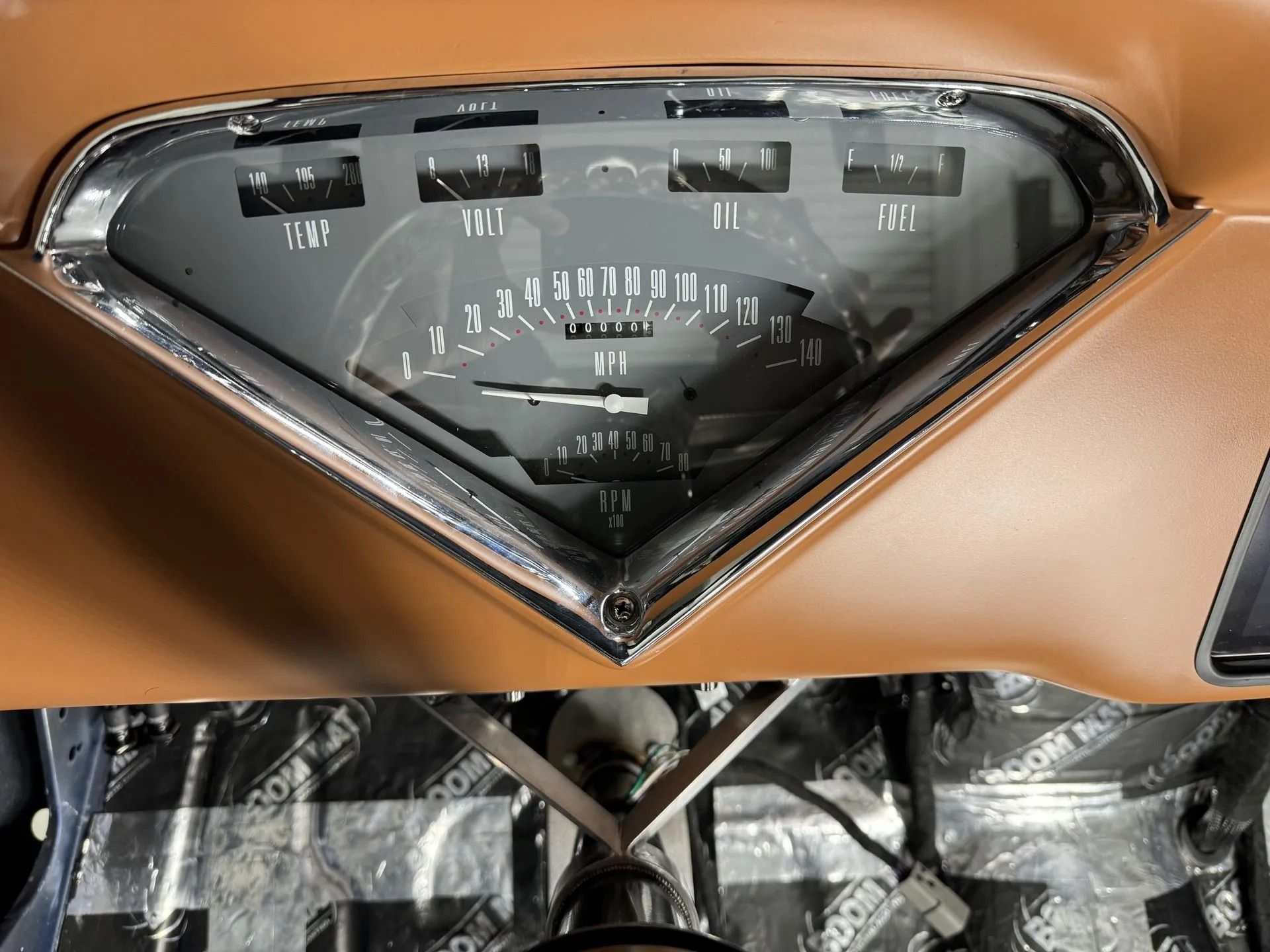 A close up of a car dashboard with a tachometer that says ' rpm ' on it