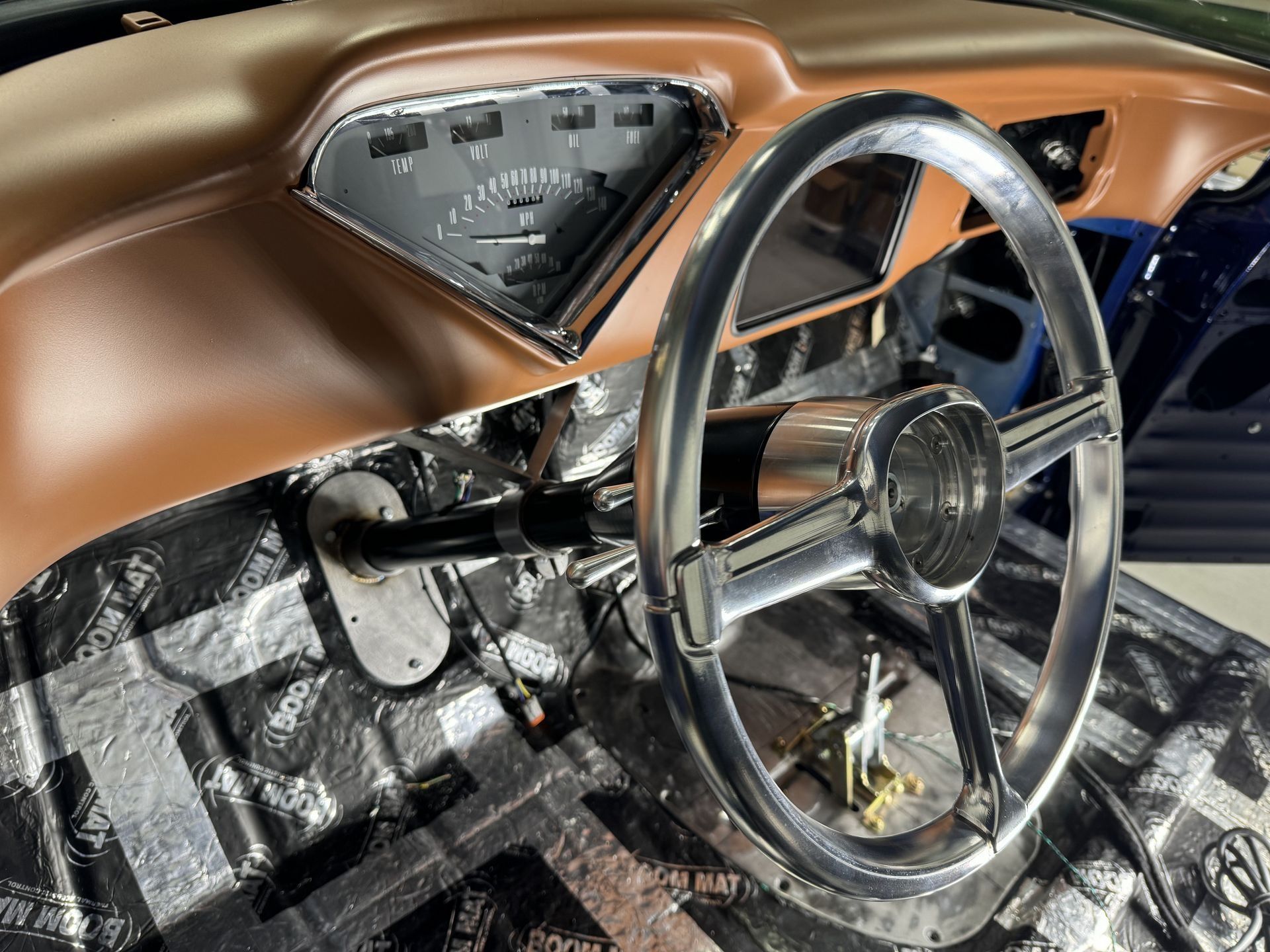 A close up of a car dashboard with a steering wheel