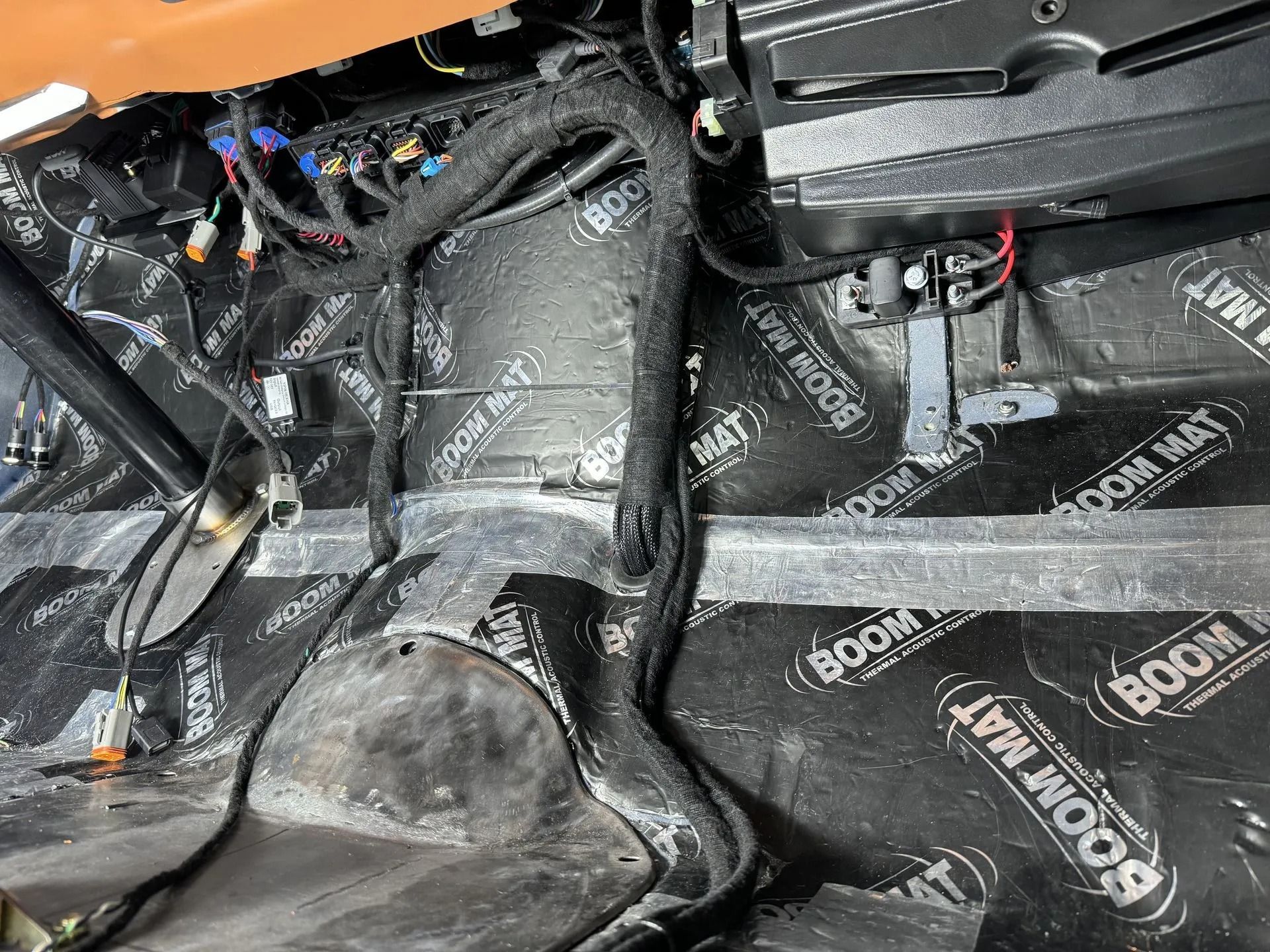 A close up of a car with a lot of wires coming out of it.