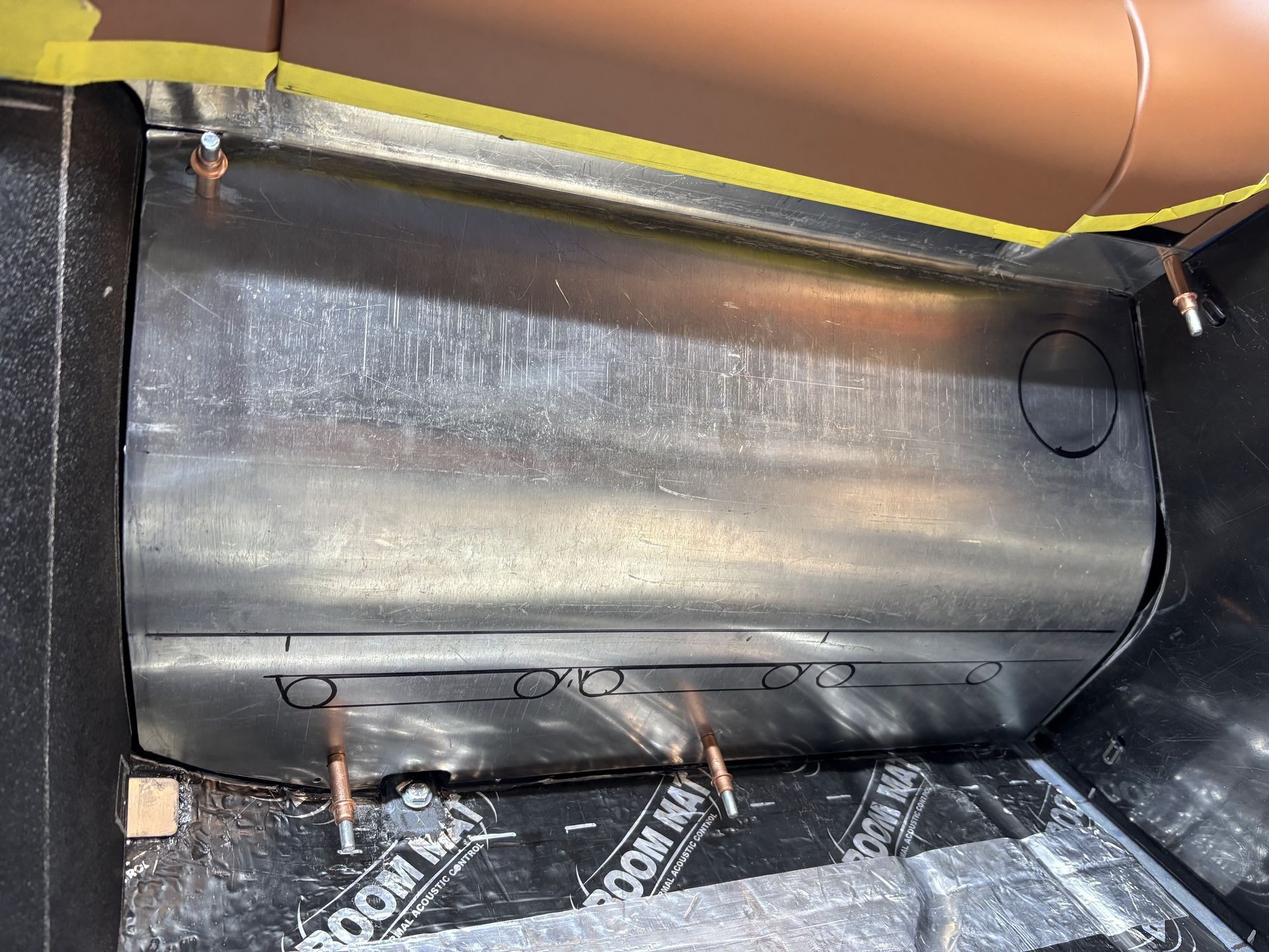 A large metal object is sitting on top of a black surface.