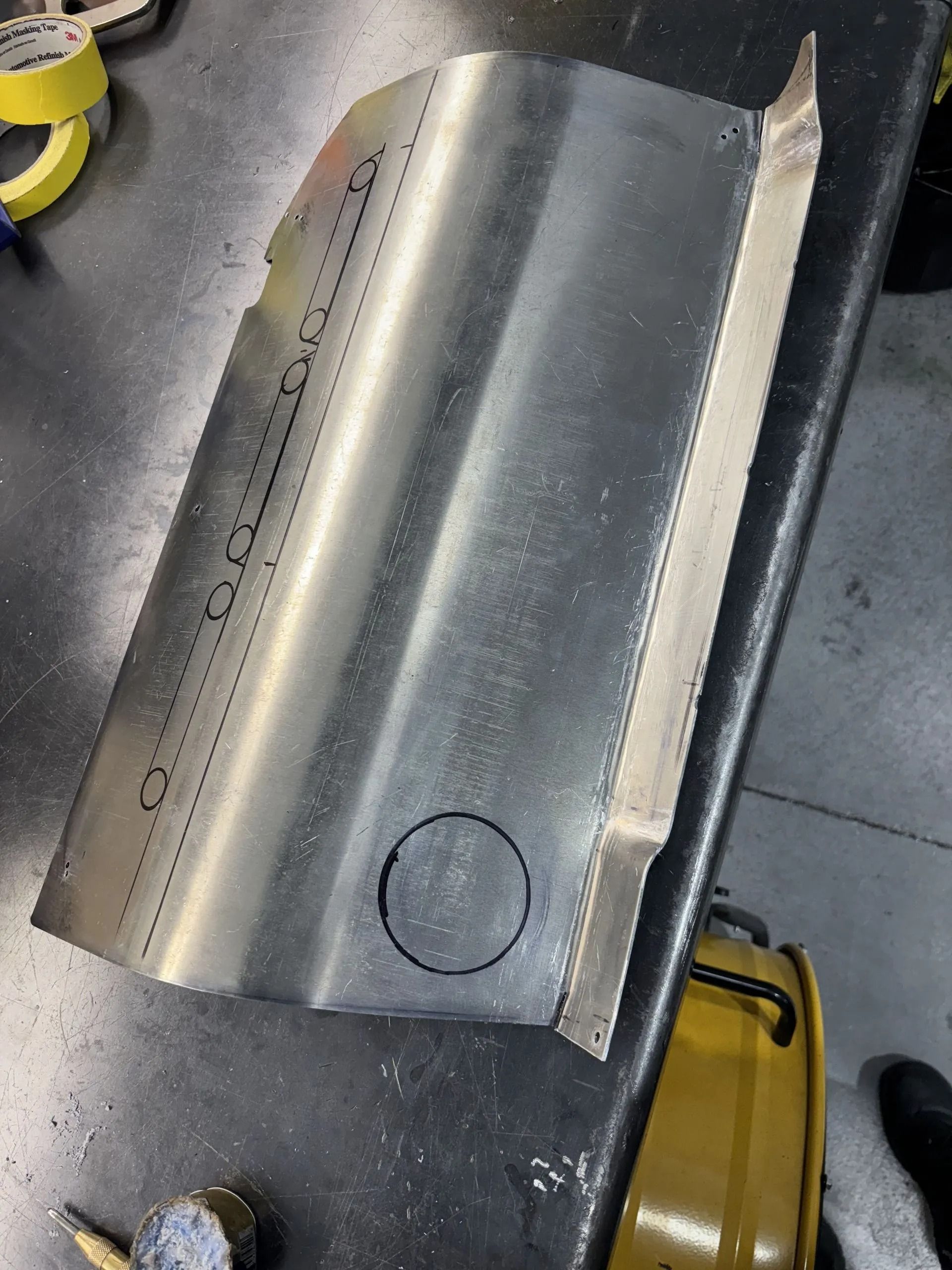 A piece of metal with a hole in the middle is sitting on a table.