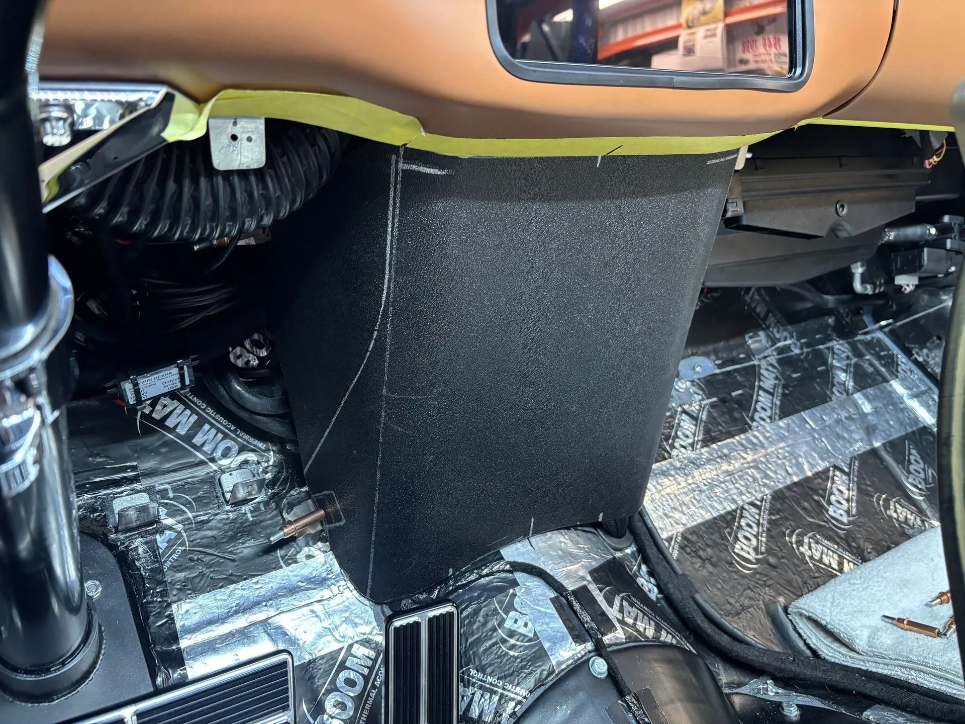The inside of a car with a black box on the floor